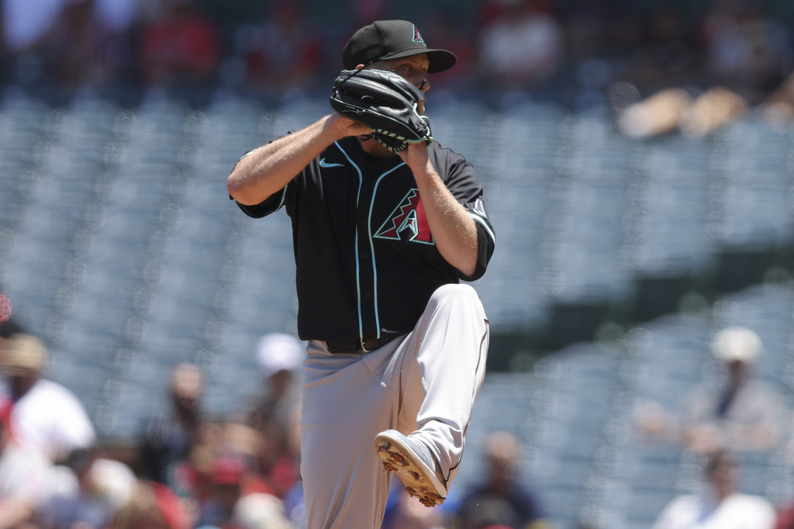 Arizona Diamondbacks pitcher Merrill Kelly prepares to throw to a...