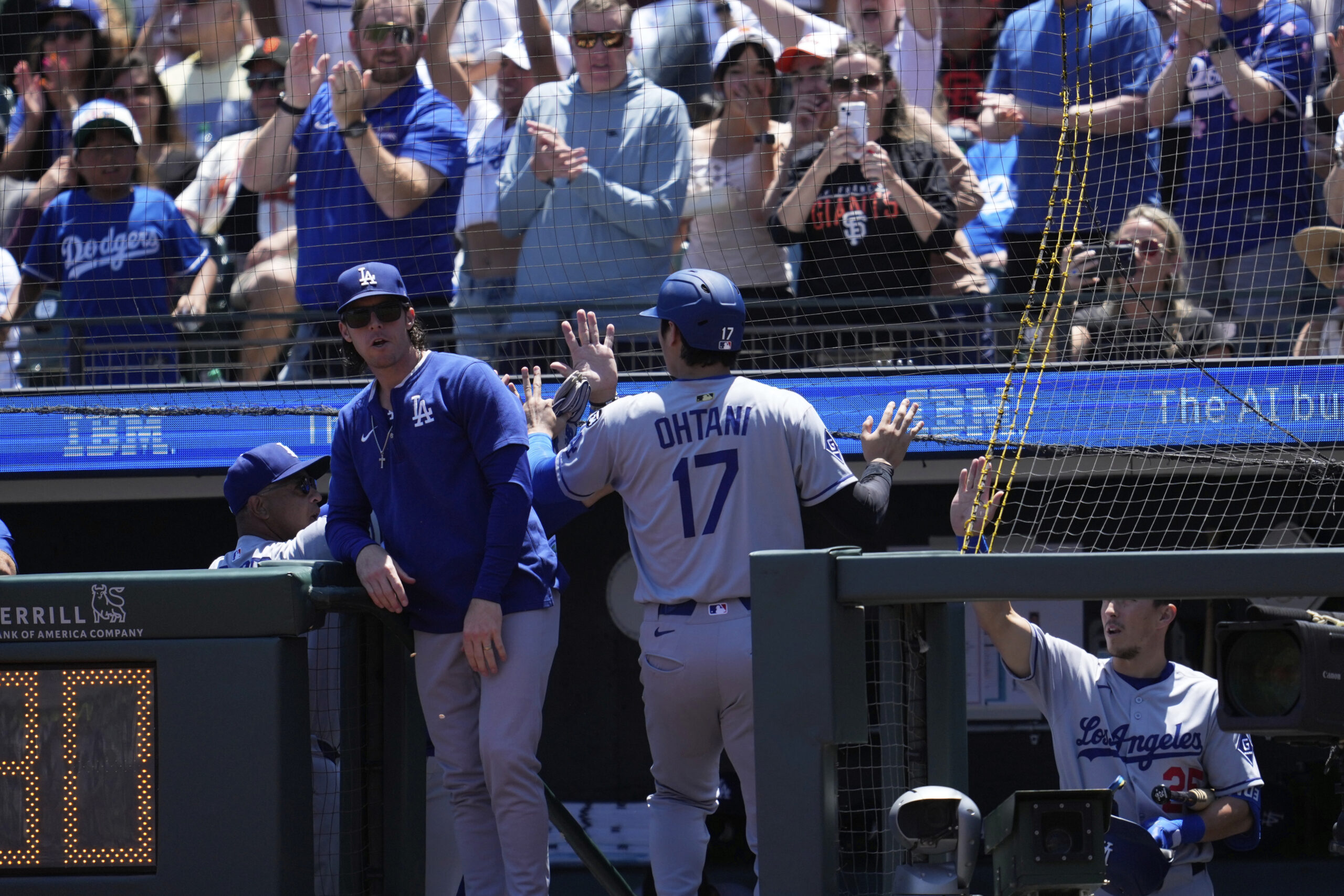 Dodgers’ Shohei Ohtani (17) is congratulated by teammates after scoring...