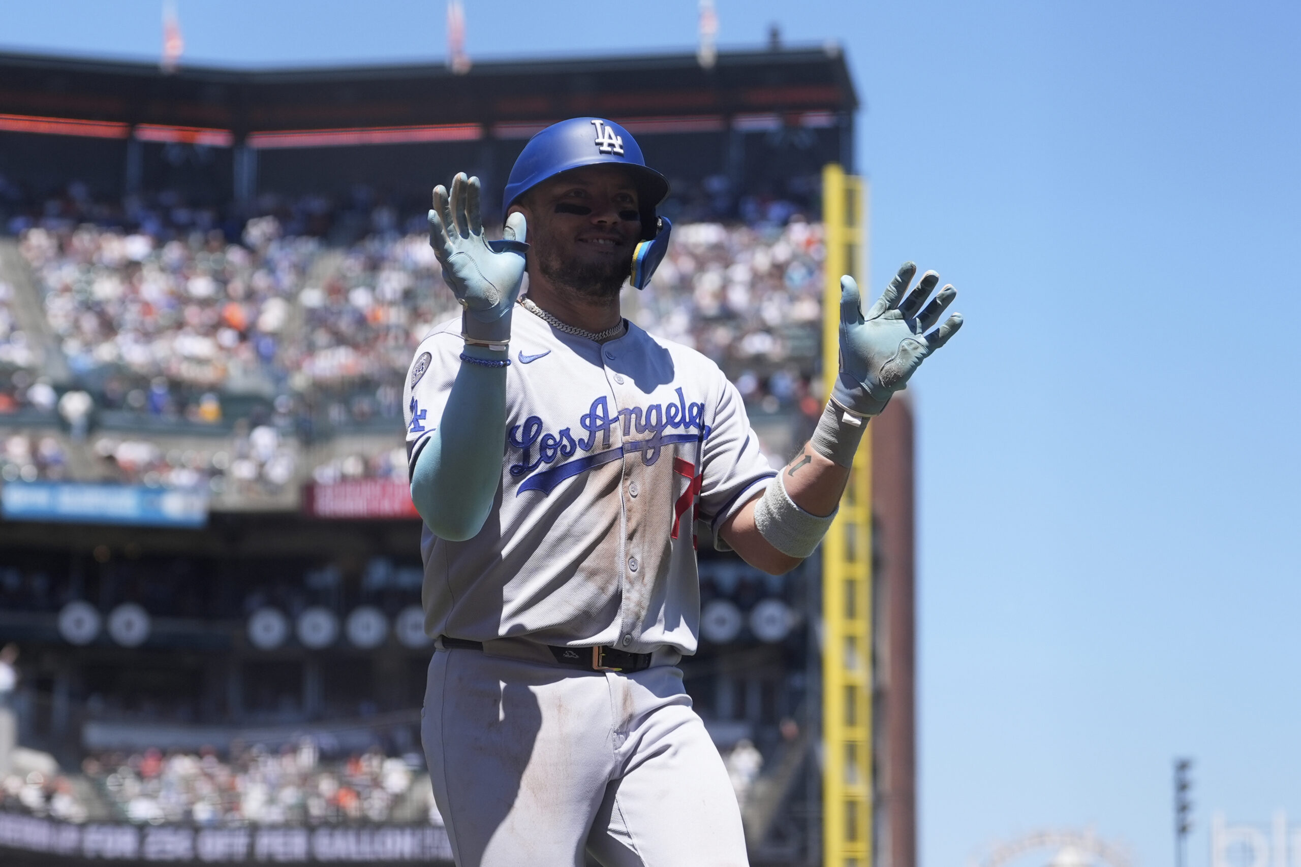 Dodgers’ Miguel Rojas reacts after hitting a home run during...