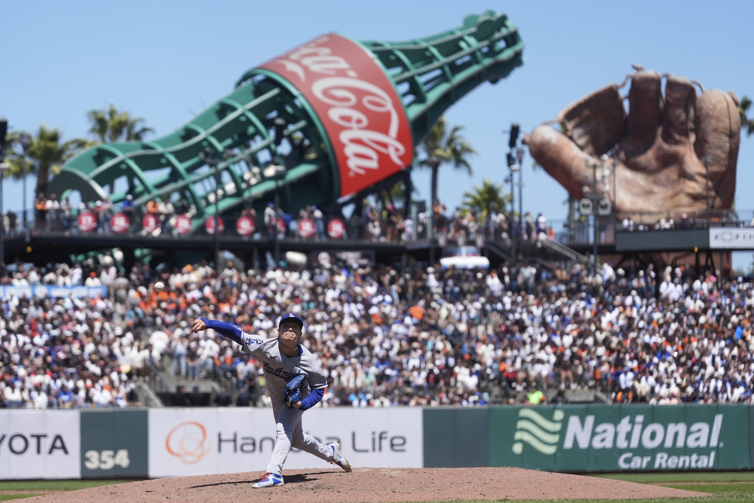 Dodgers pitcher Yoshinobu Yamamoto throws against the San Francisco Giants...