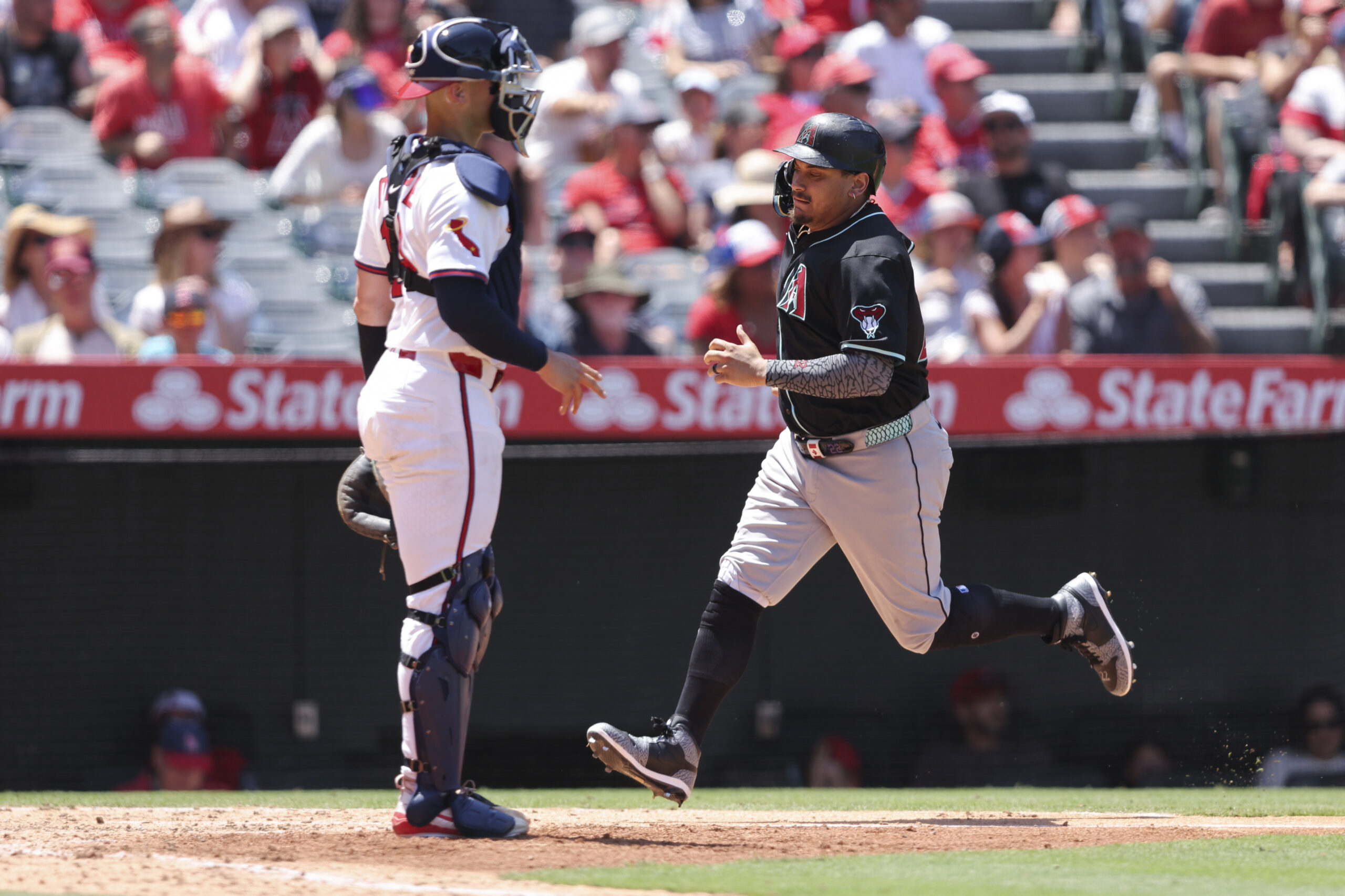 Arizona’s Josh Naylor scores as Angels catcher Logan O’Hoppe watches...