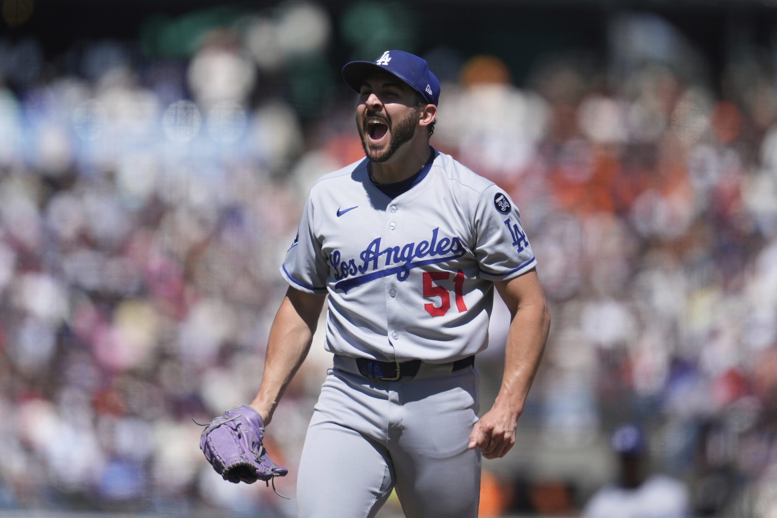 Dodgers pitcher Alex Vesia (51) reacts after striking out San...