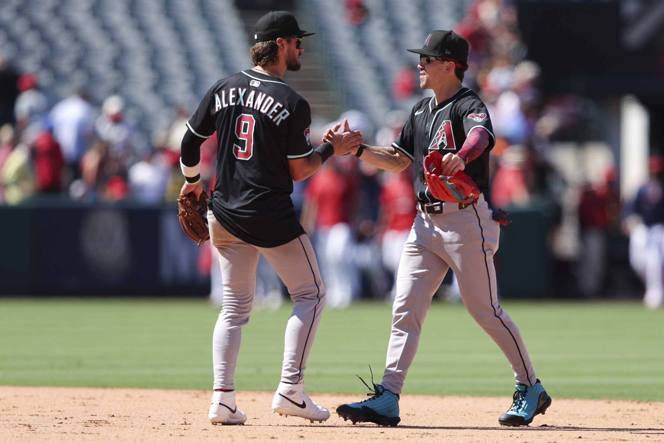 Arizona Diamondbacks’ Blaze Alexander (9) and Corbin Carroll, right, shake...
