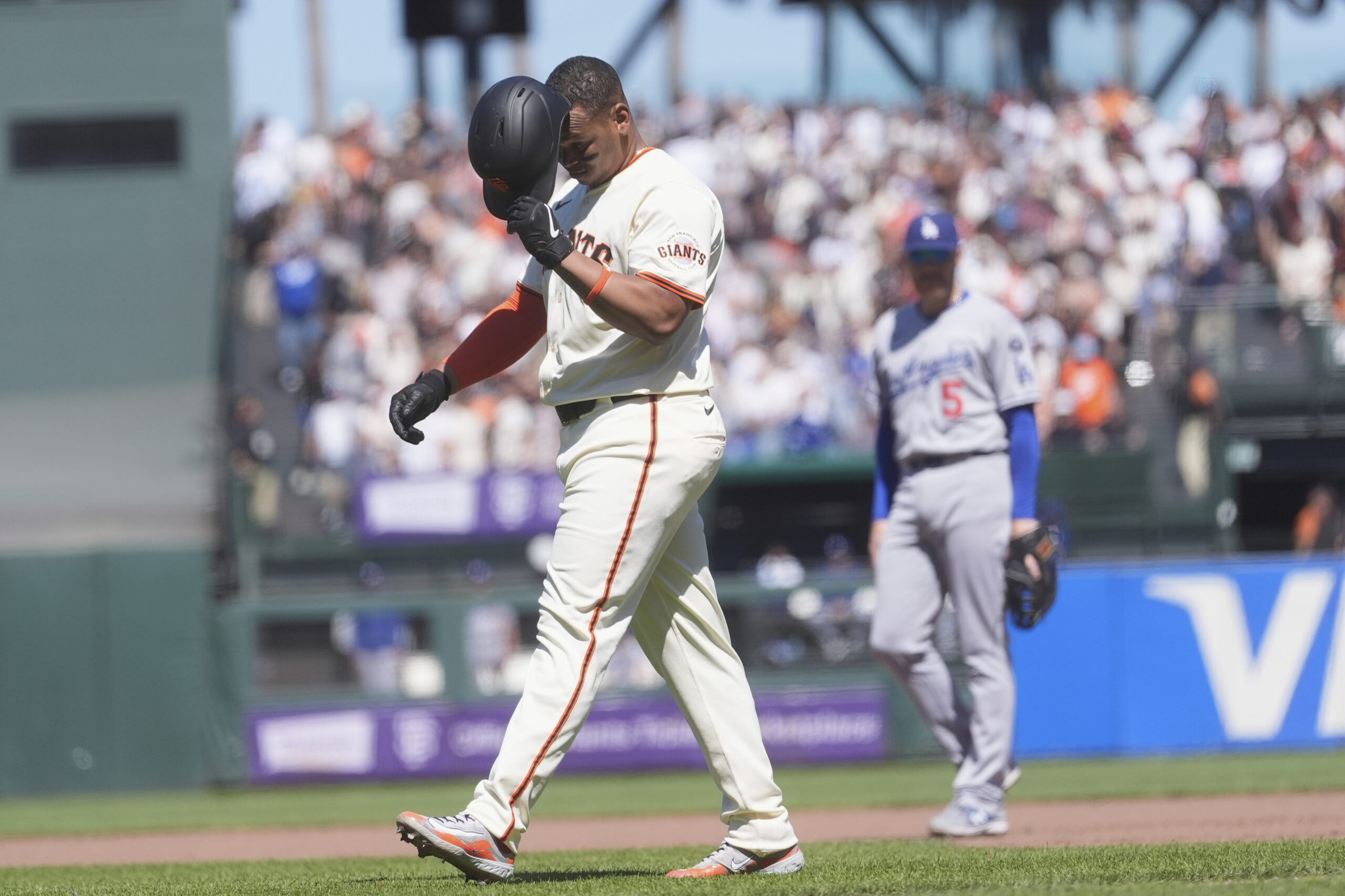 San Francisco Giants’ Rafael Devers, left, reacts after lining out...