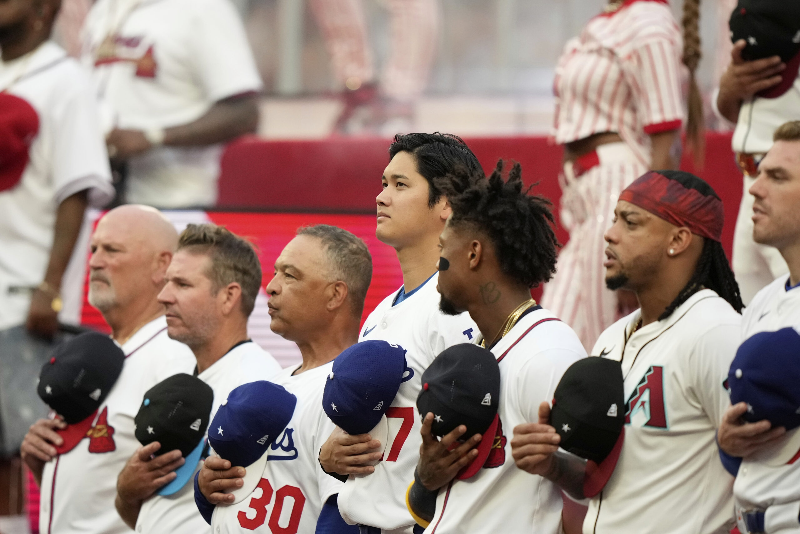 The Dodgers’ Shohei Ohtani, center, stands with his National League...