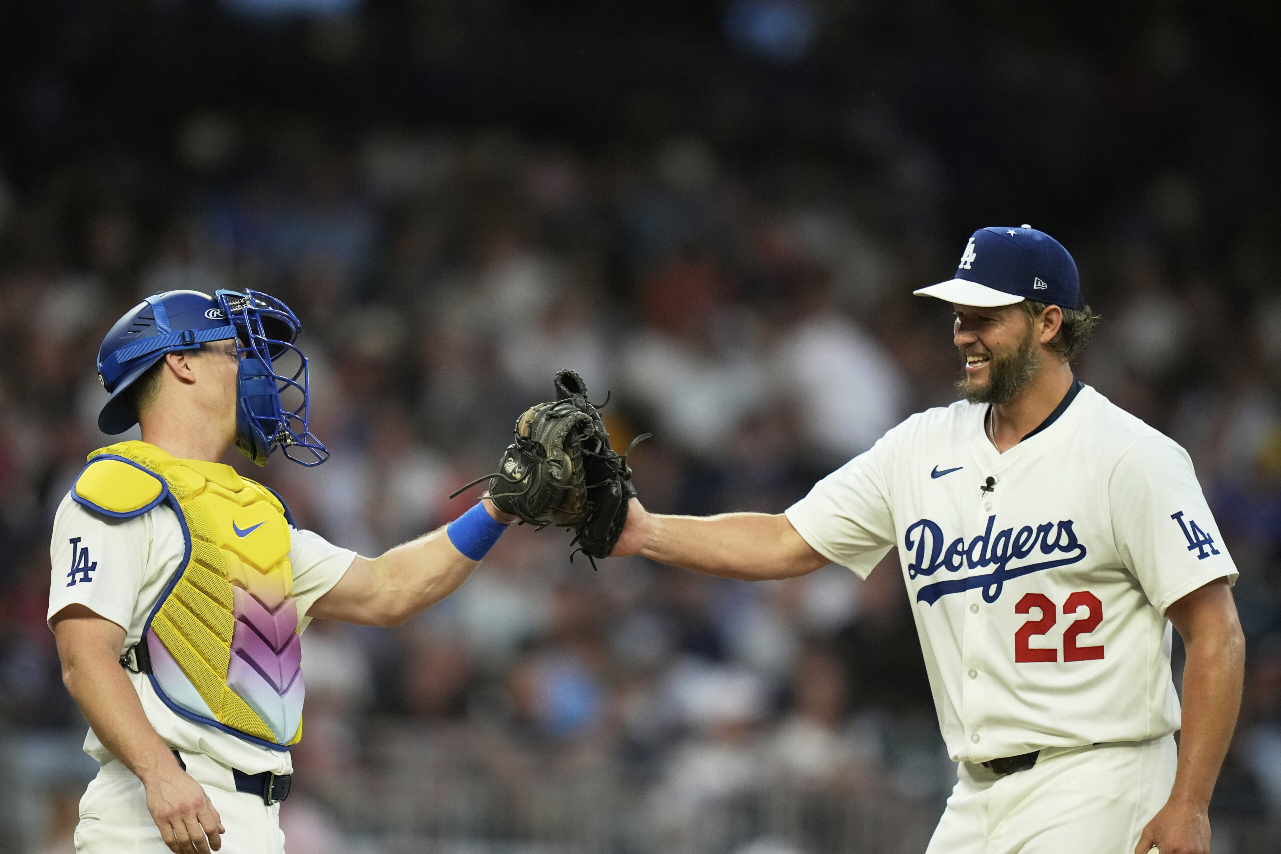 Dodgers pitcher Clayton, Kershaw greets Dodgers catcher Will Smith as...
