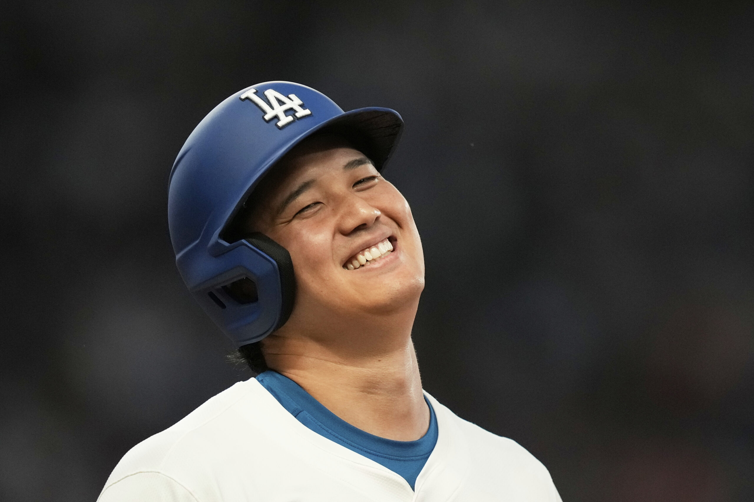 The Dodgers’ Shohei Ohtani smiles after grounding out during the...