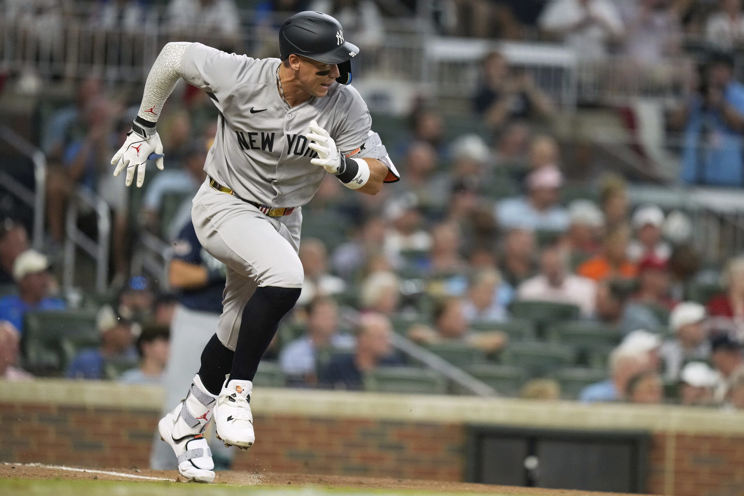 The New York Yankees’ Aaron Judge runs to first during...