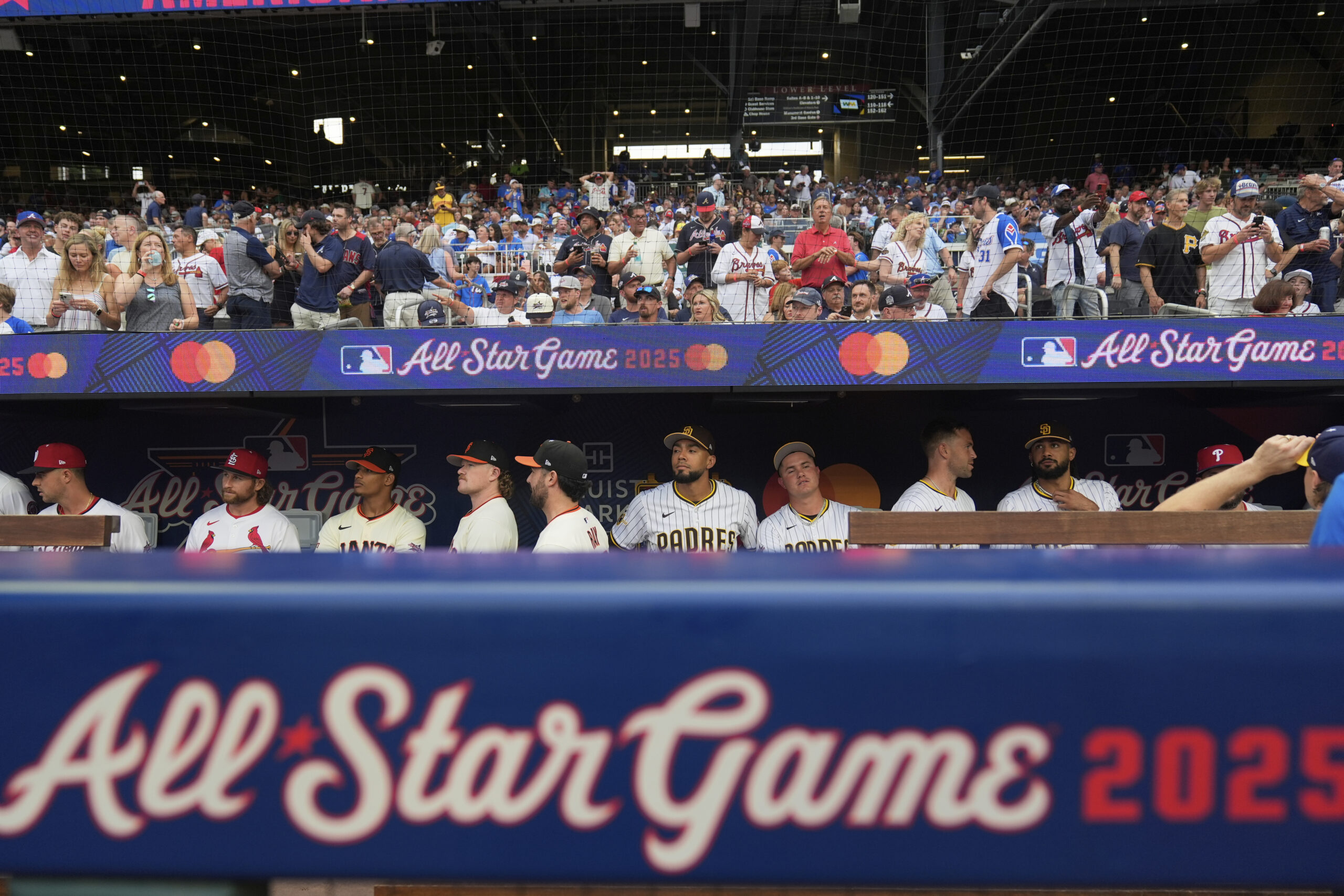 The National League team watches from the dugout during the...