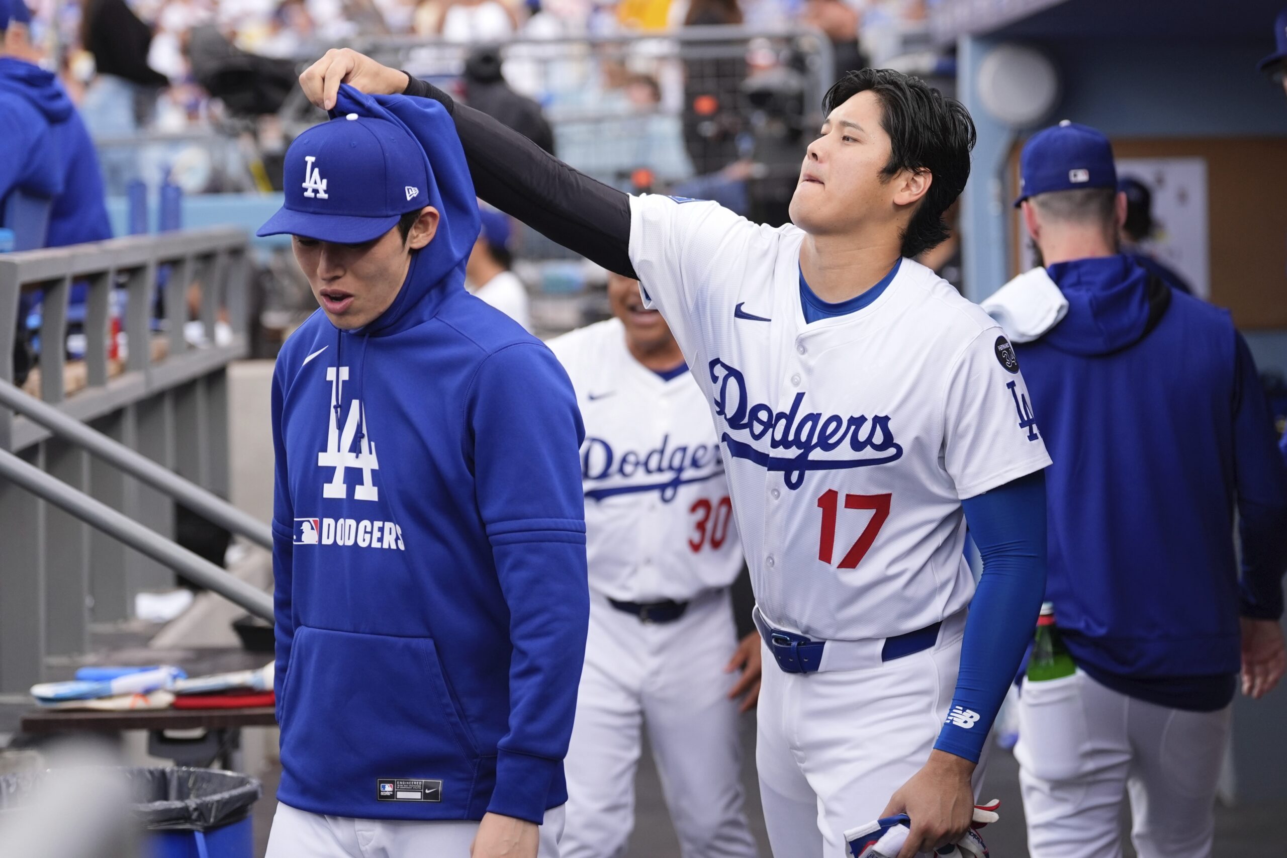 Dodgers star Shohei Ohtani, right, jokes around with teammate Roki...