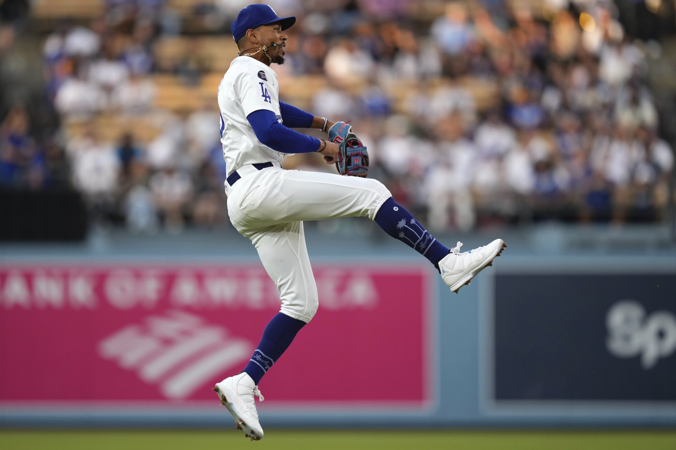 Dodgers shortstop Mookie Betts makes a leaping throw but is...