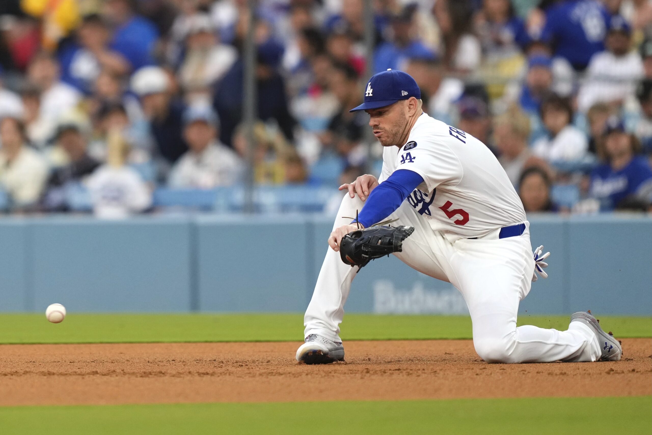 Dodgers first baseman Freddie Freeman loses his glove as he...