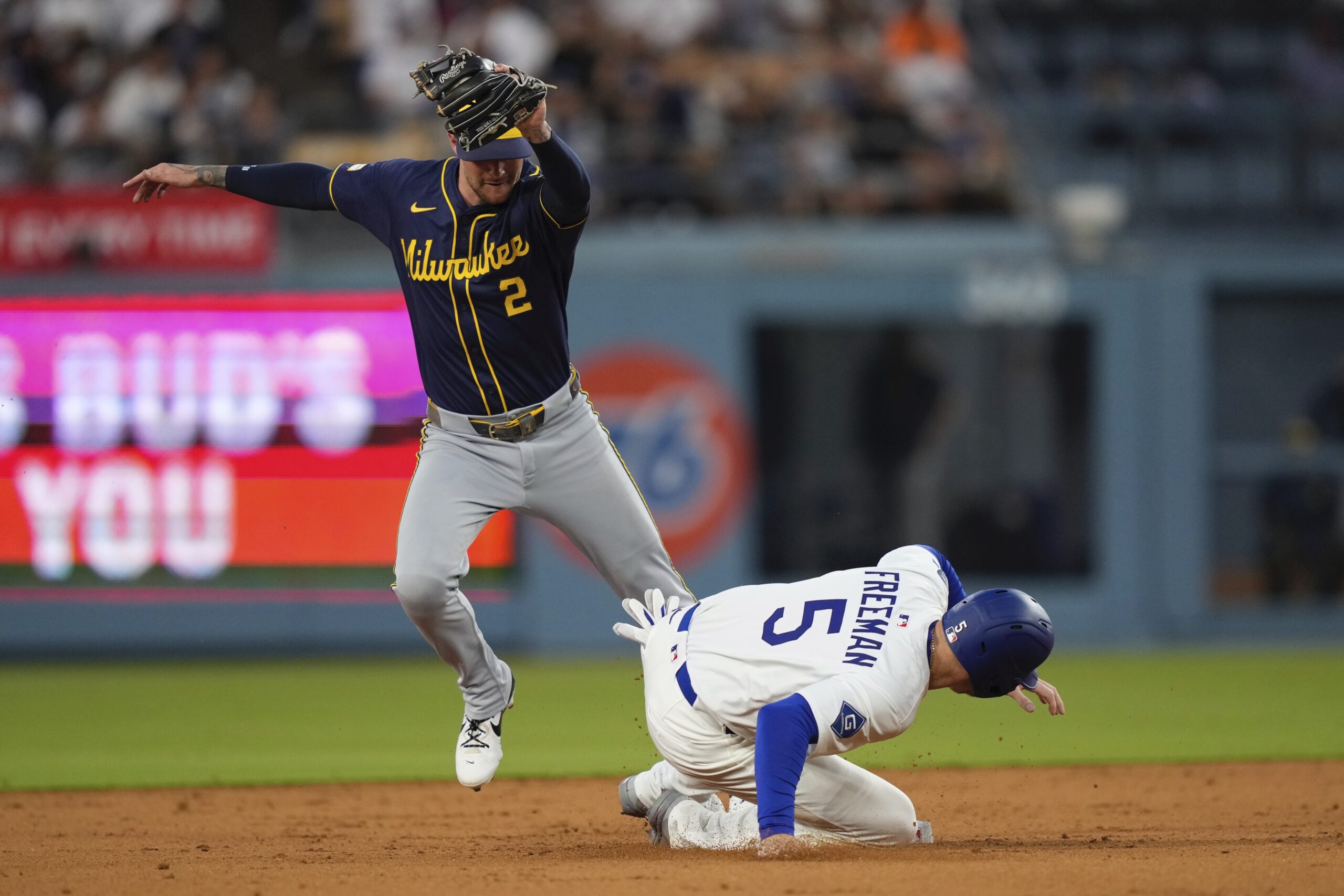 The Dodgers’ Freddie Freeman, right, is forced out at second...
