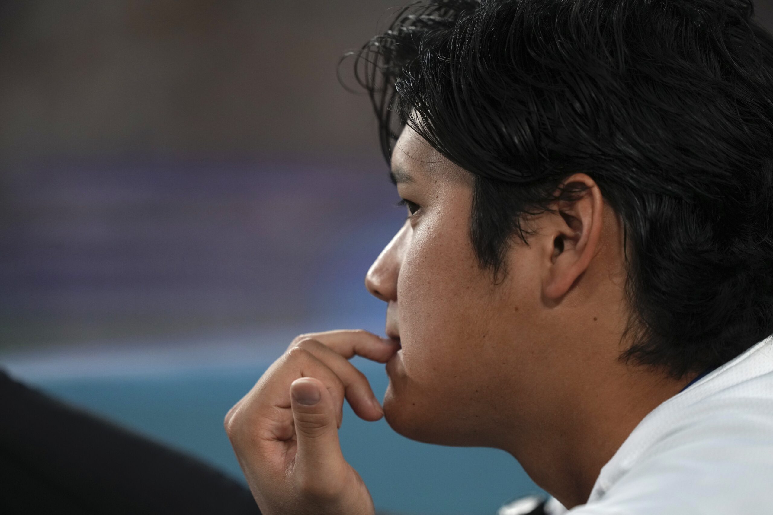 Dodgers star Shohei Ohtani watches from the dugout during the...