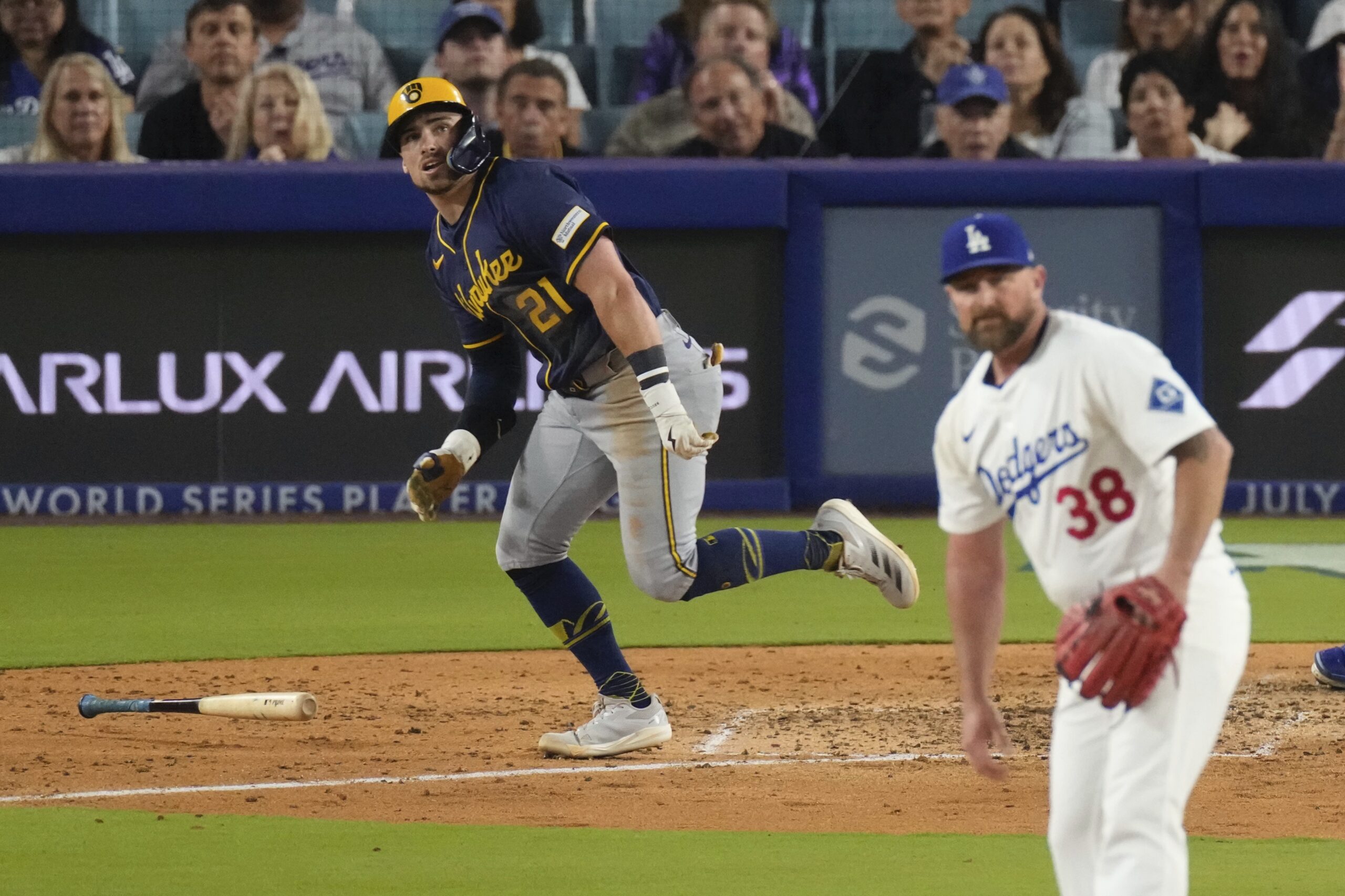 The Milwaukee Brewers’ Caleb Durbin, left, begins to run the...