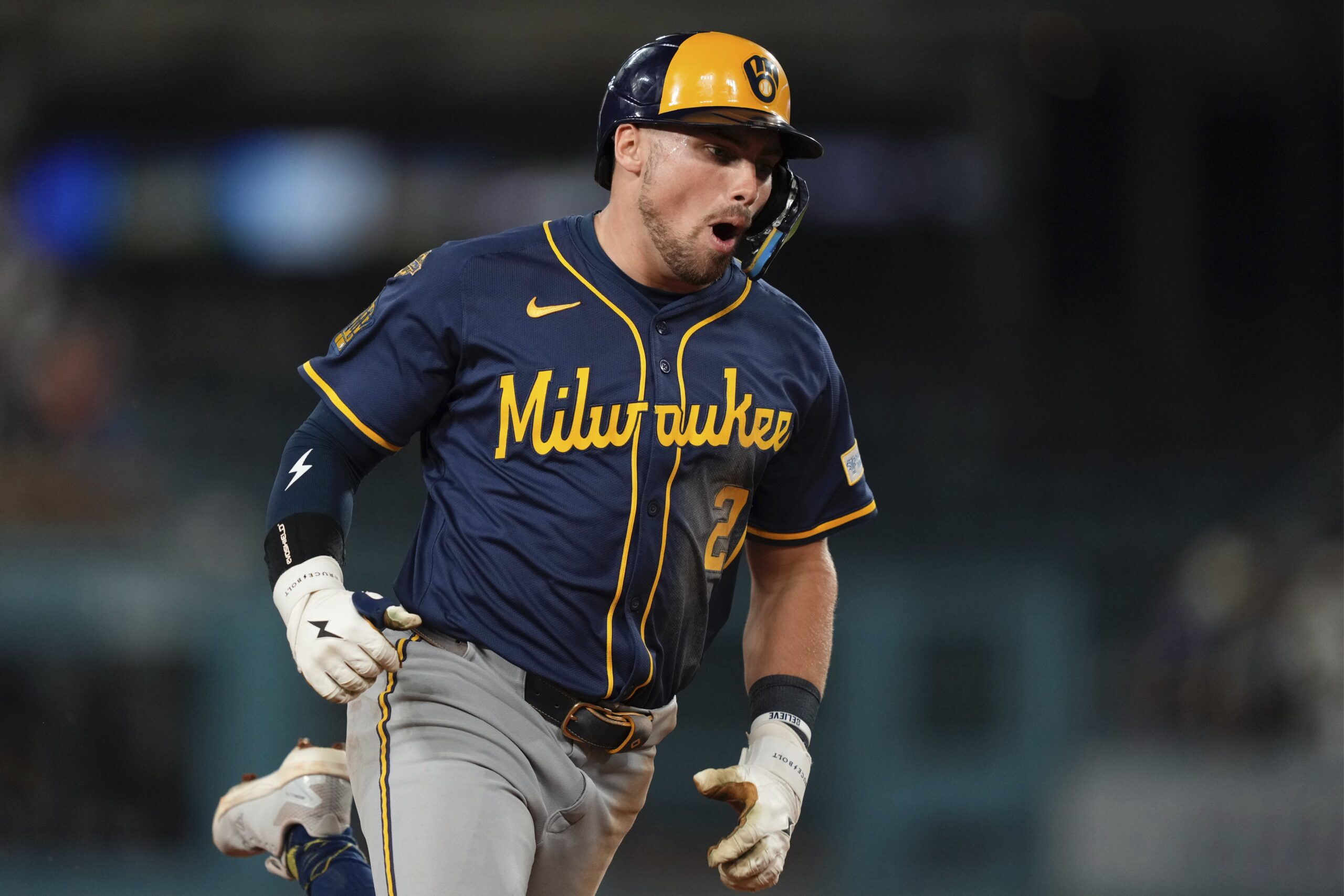 The Milwaukee Brewers’ Caleb Durbin celebrates as he runs the...