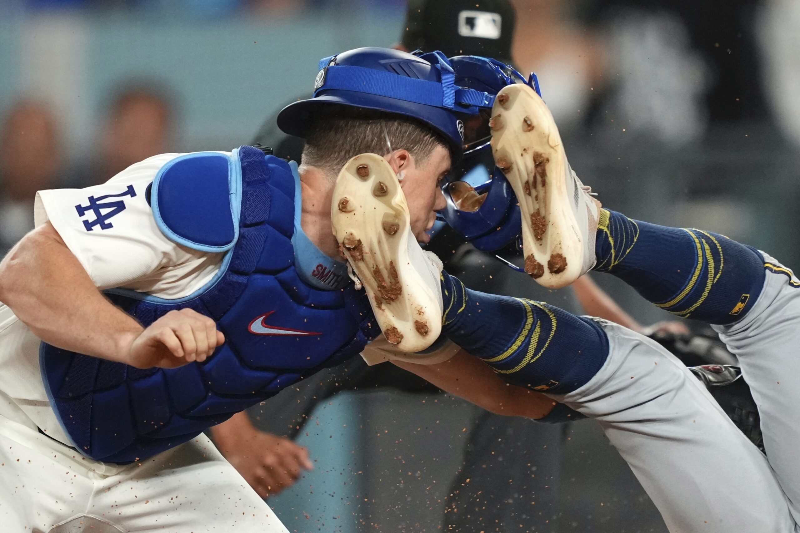 Dodgers catcher Will Smith, left, has his mask and helmet...