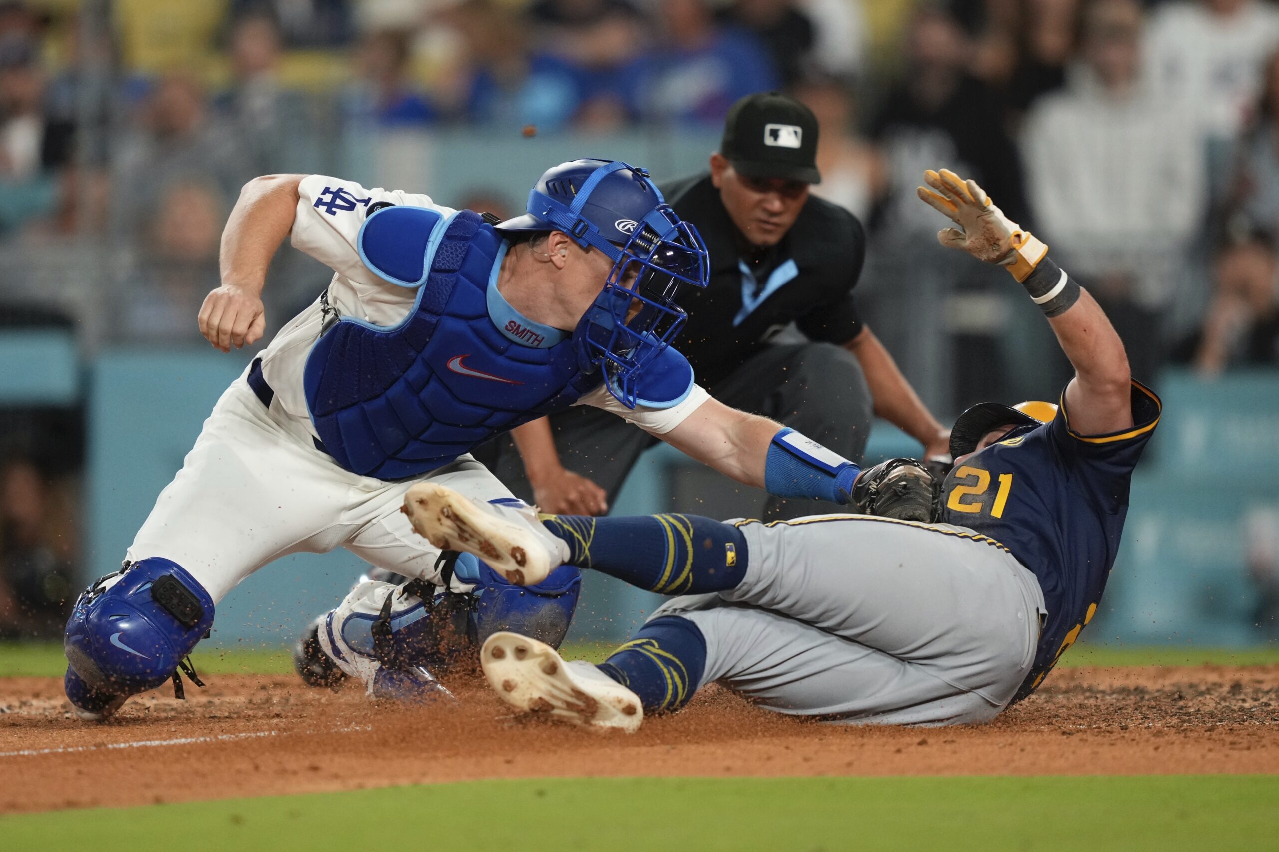 Dodgers catcher Will Smith, left, tags out the Milwaukee Brewers’...