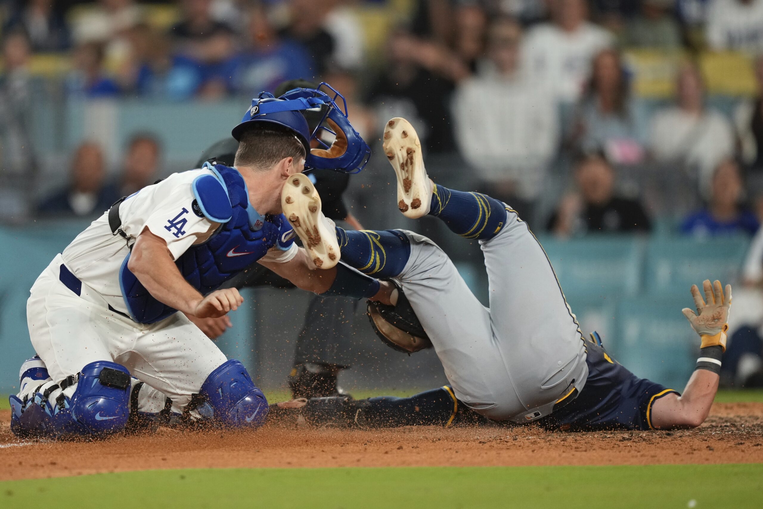 Dodgers catcher Will Smith, left, has his mask and helmet...