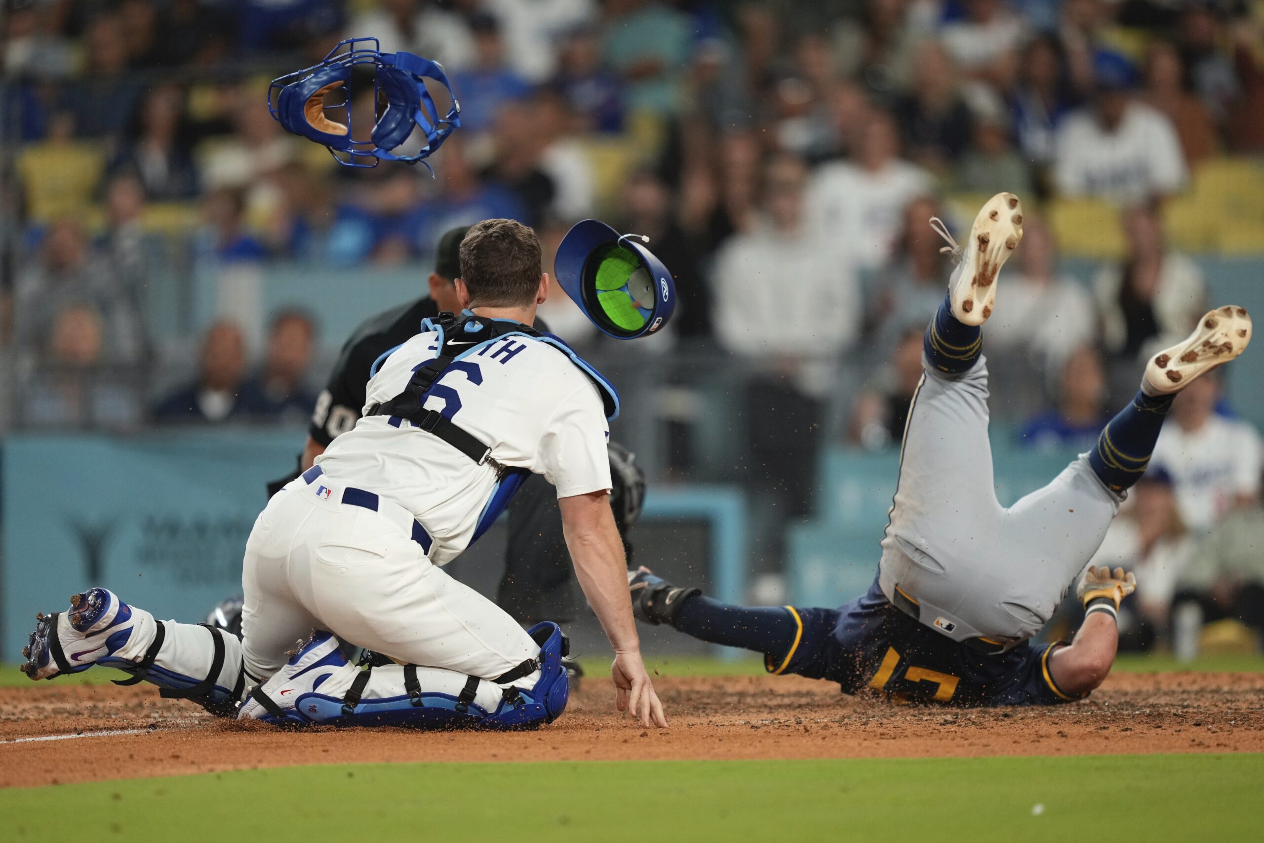 Dodgers catcher Will Smith, left, has his mask and helmet...