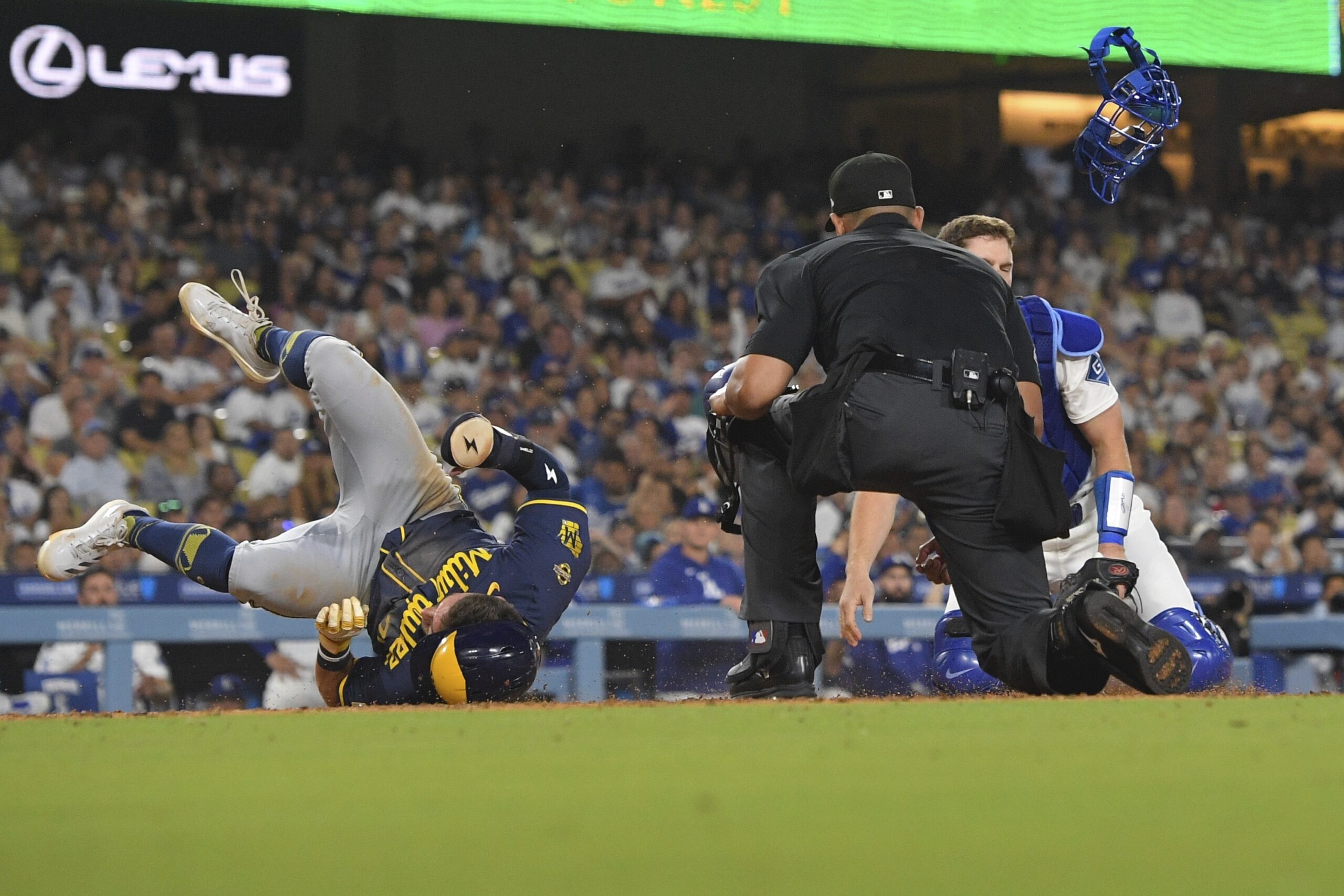 Dodgers catcher Will Smith, right, has his mask and helmet...