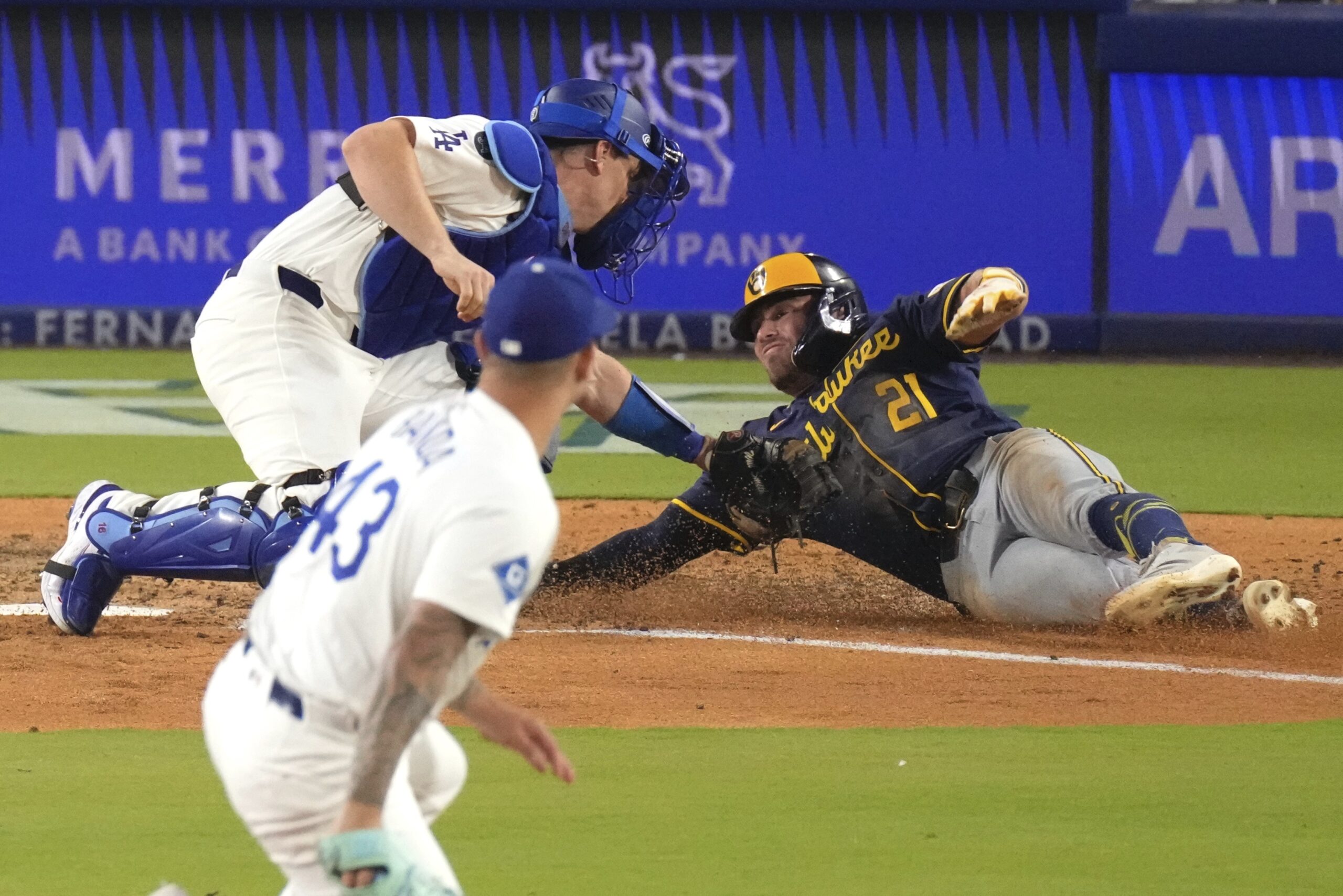 Dodgers catcher Will Smith, center, tags out the Milwaukee Brewers’...
