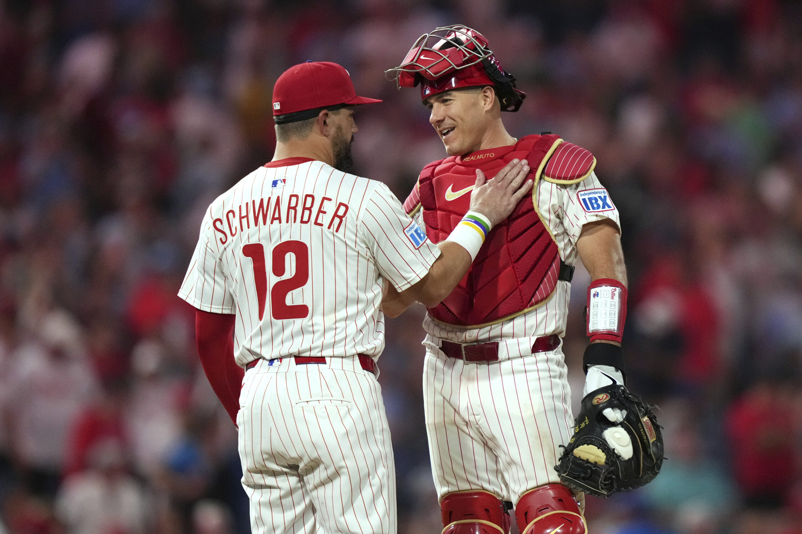 Philadelphia Phillies catcher J.T. Realmuto, right, and designated hitter Kyle...
