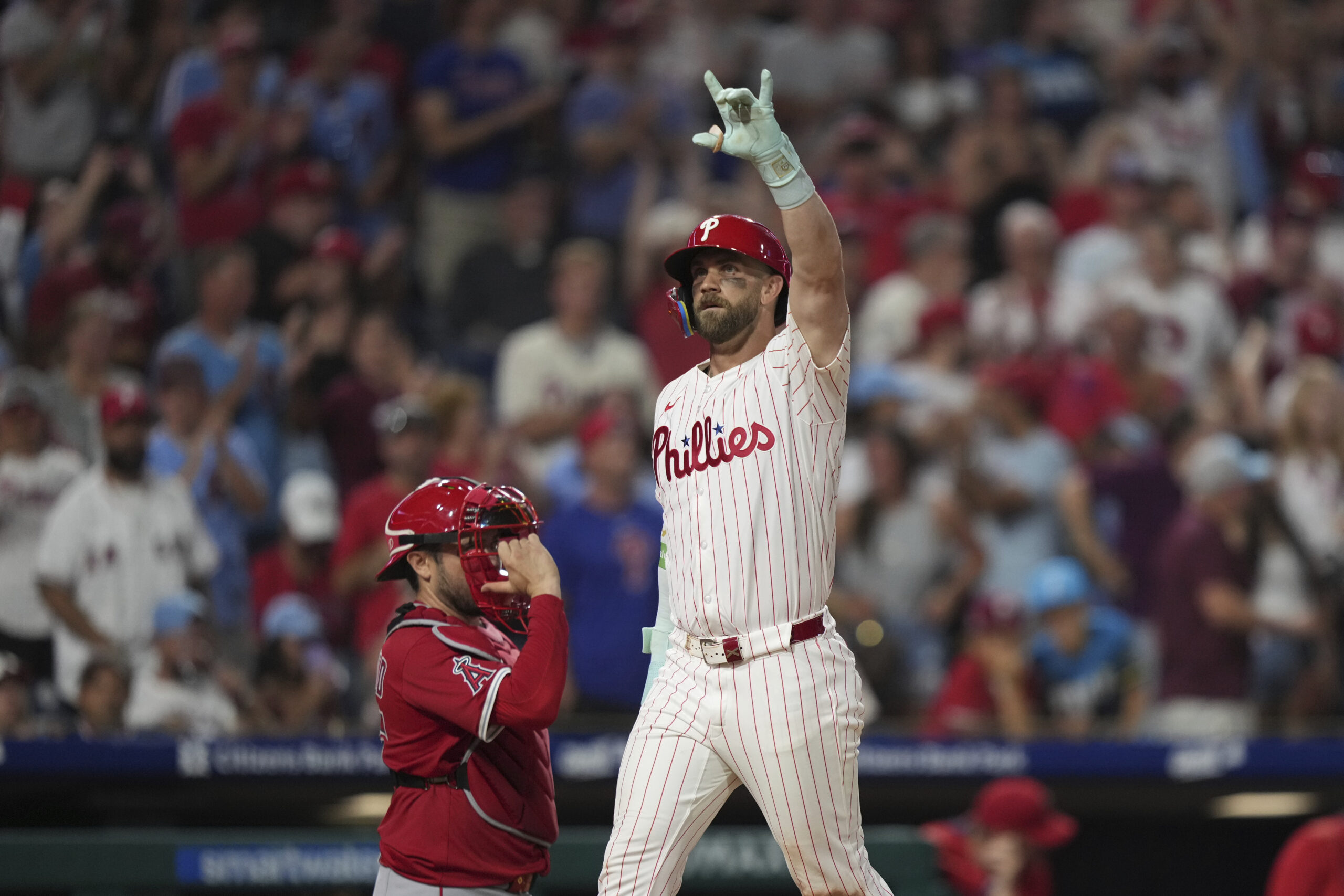 Philadelphia Phillies’ Bryce Harper reacts after a home run during...
