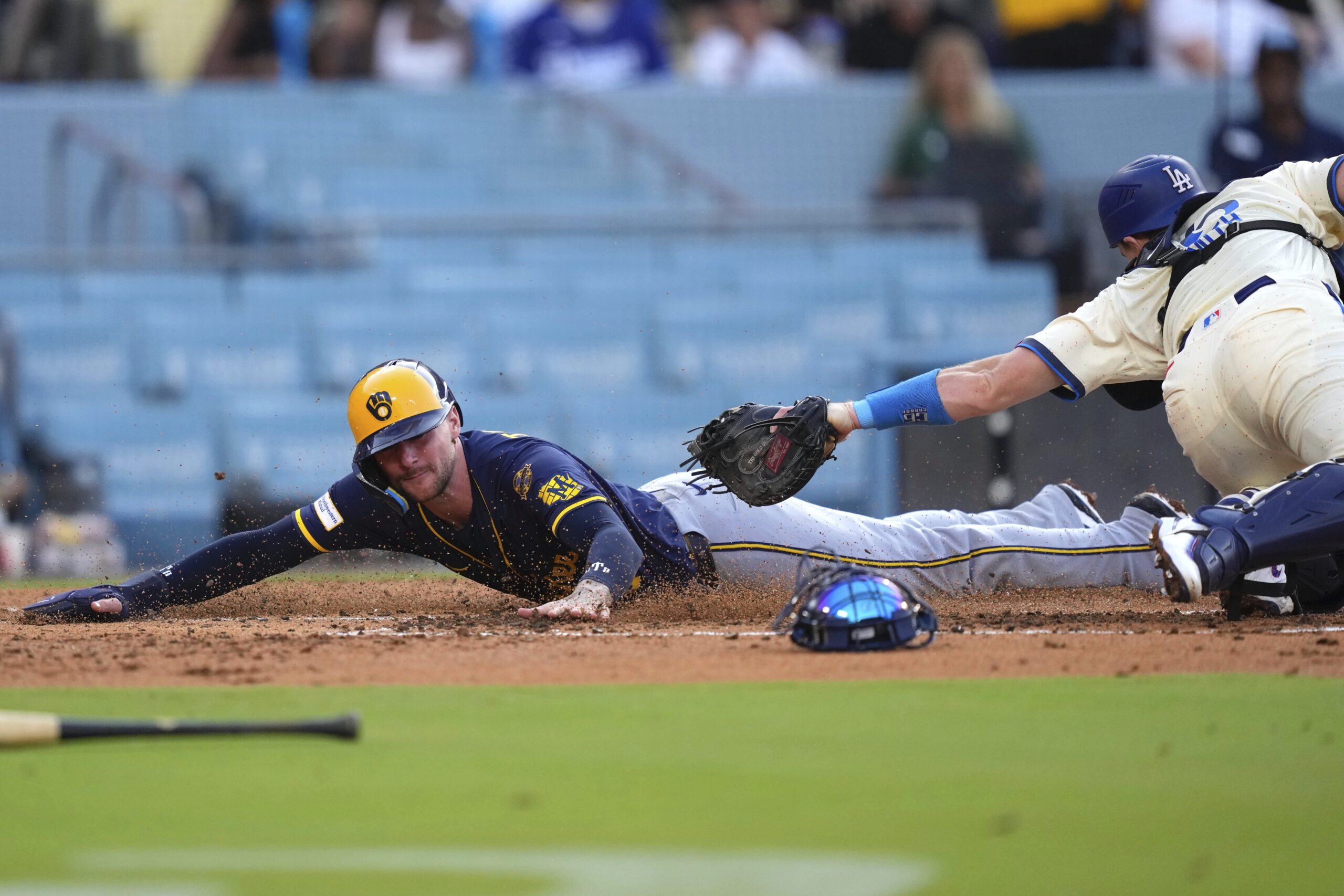 Milwaukee Brewers’ Brice Turang, left, scores on a double by...
