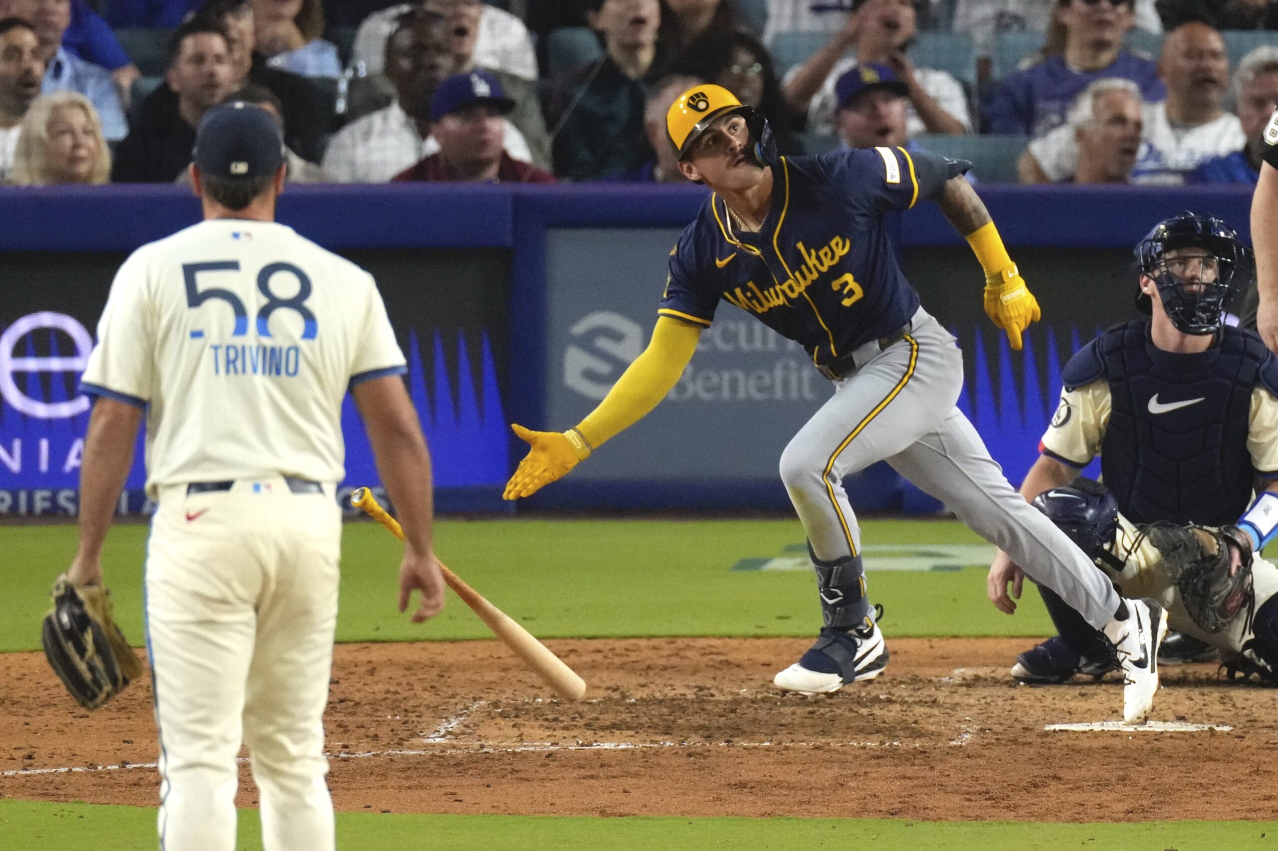 Milwaukee Brewers’ Joey Ortiz, center, heads to first for a...