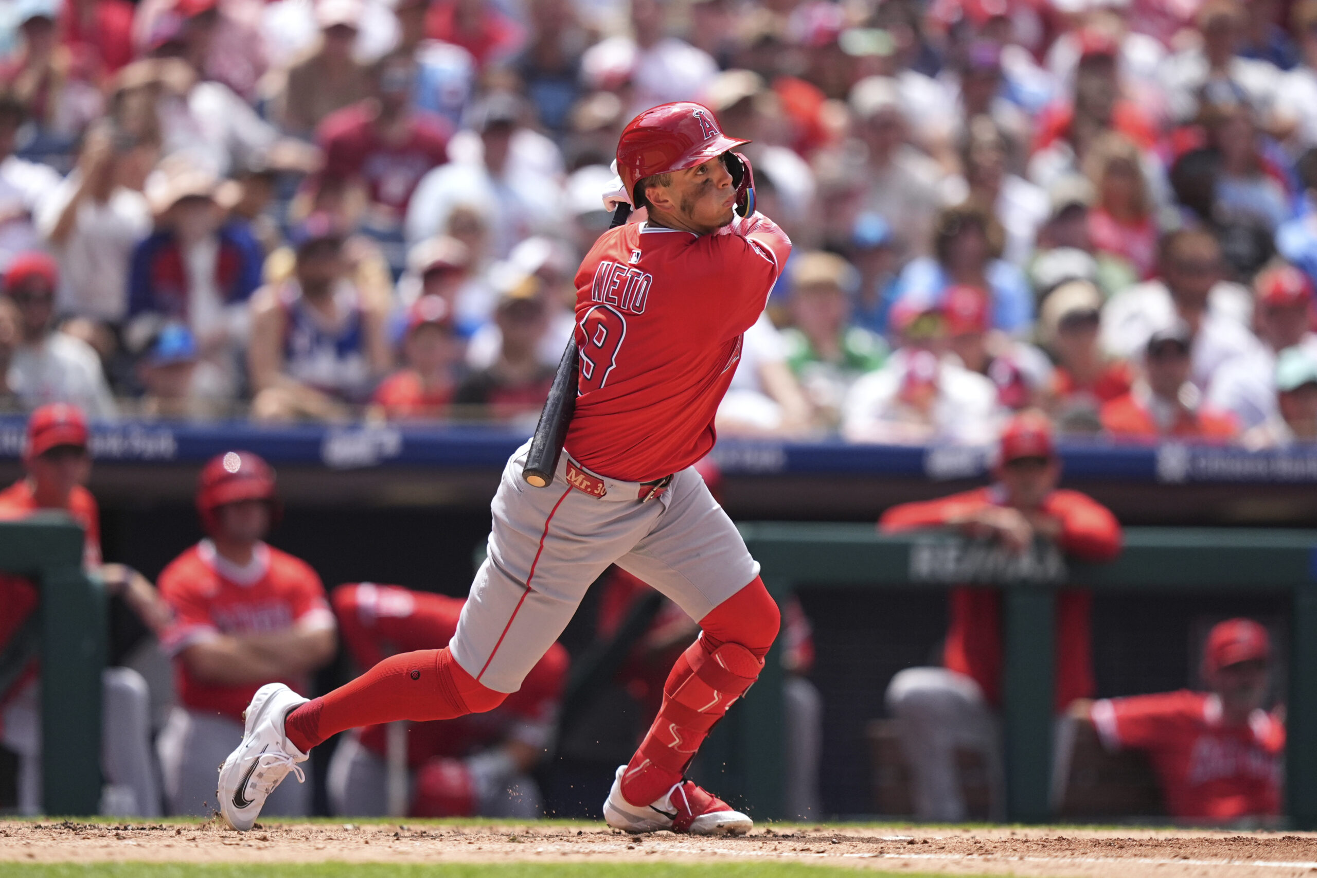 Angels’ Zach Neto follows through after hitting a three-run single...