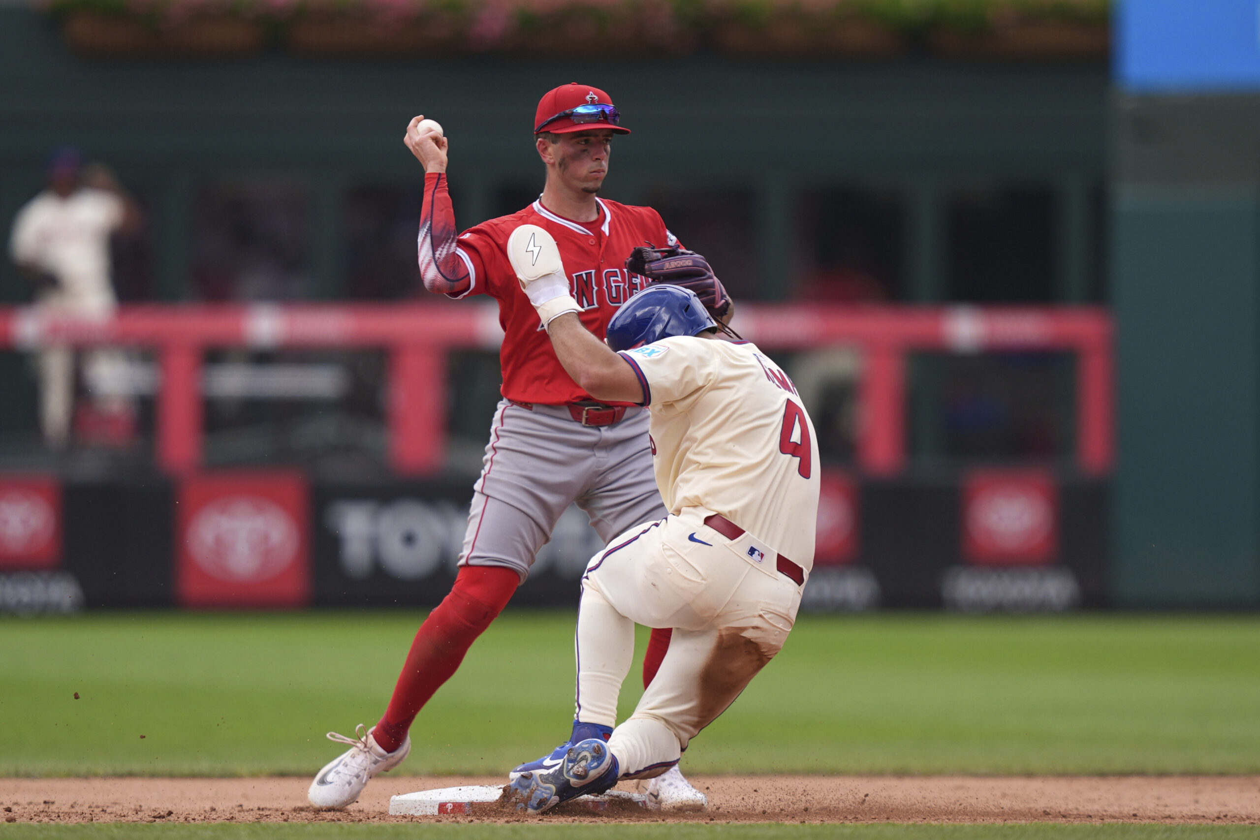 Angels shortstop Zach Neto, left, forces out Philadelphia Phillies’ Otto...