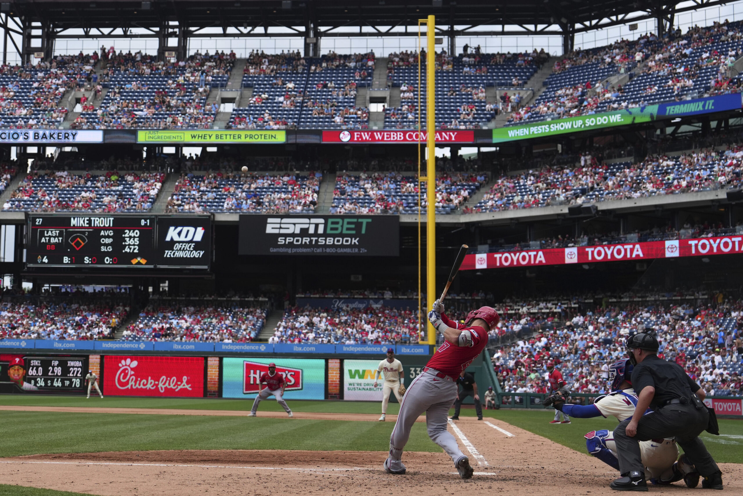 Angels’ Mike Trout hits an RBI-sacrifice fly against Philadelphia Phillies...
