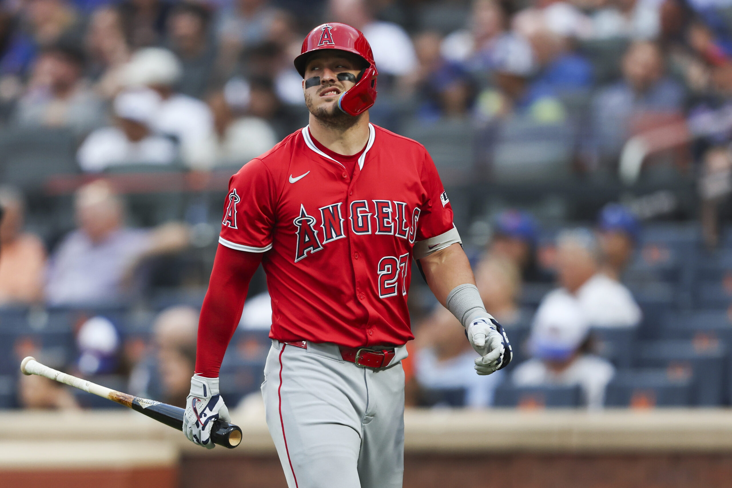 Angels star Mike Trout shows his frustration as he walks...