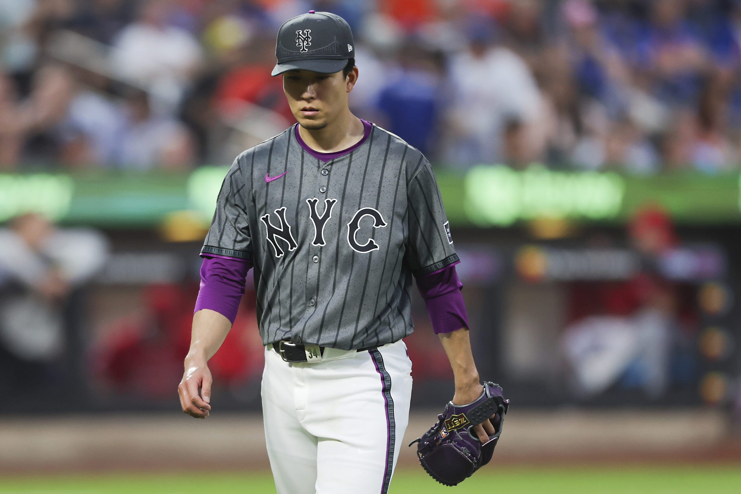 New York Mets starting pitcher Kodai Senga walks back to...