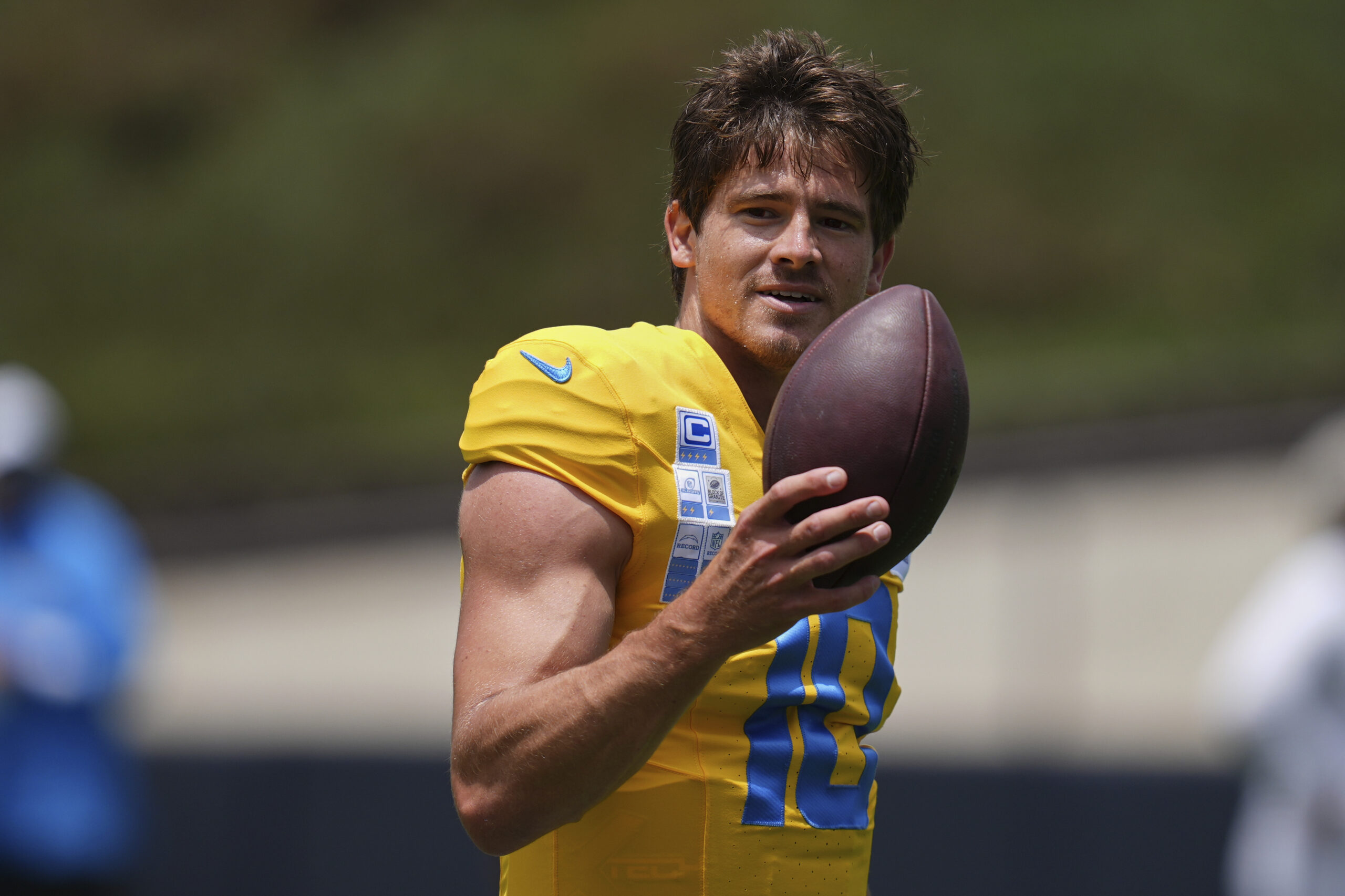 Chargers quarterback Justin Herbert smiles as he goes through a...