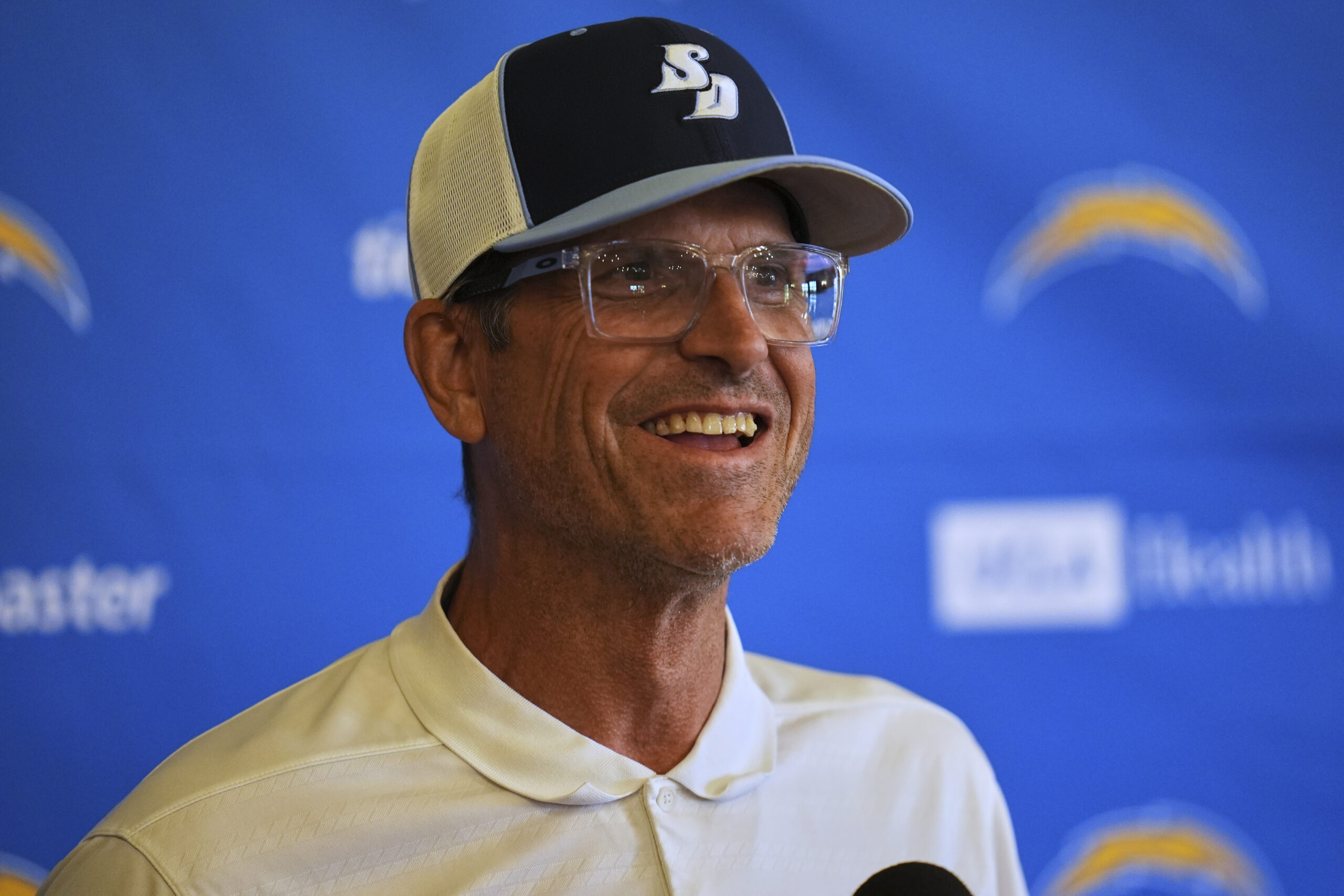 Chargers head coach Jim Harbaugh speaks to reporters during a...