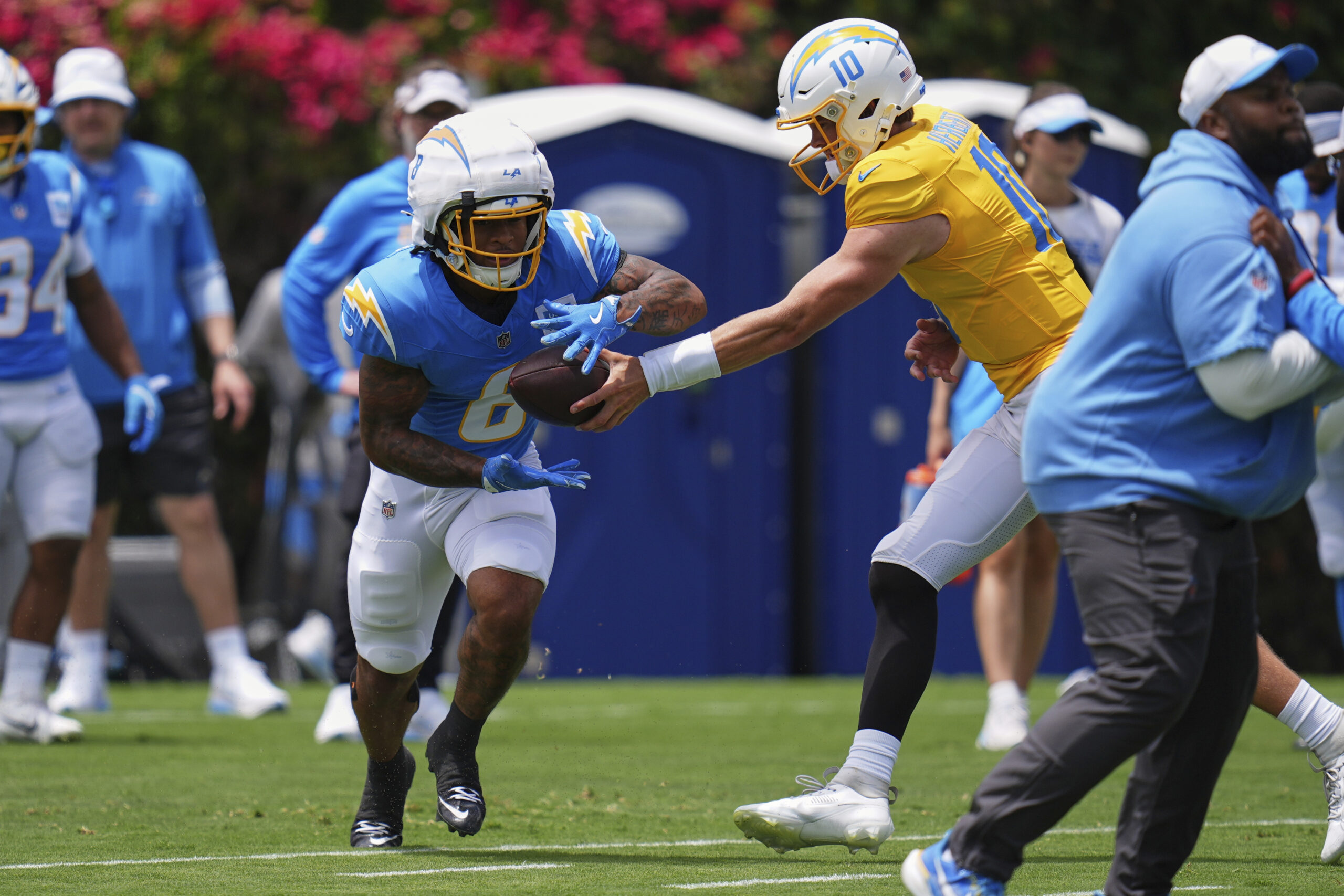 Chargers rookie running back Omarion Hampton gets a handoff from...