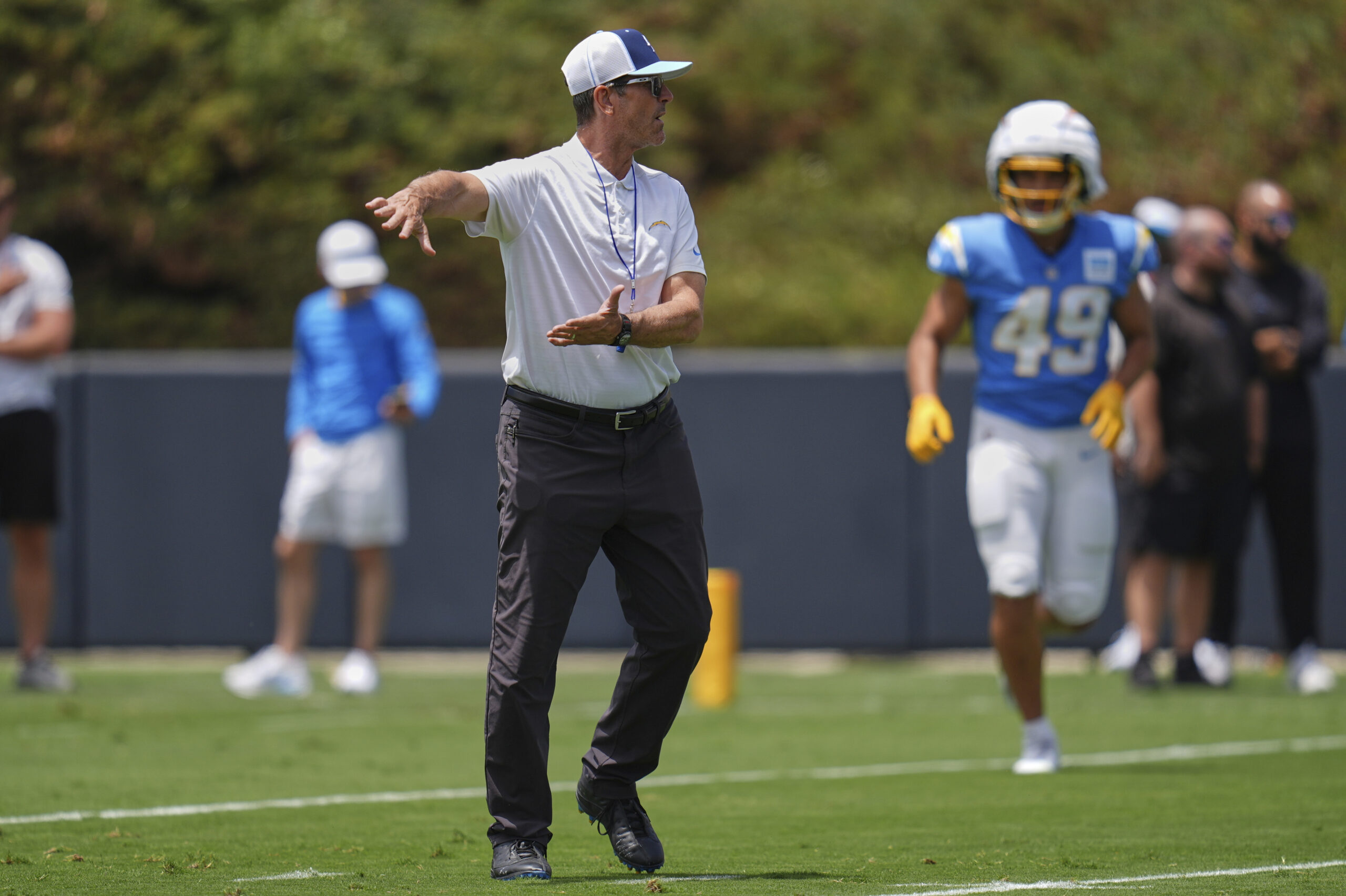 Chargers head coach Jim Harbaugh gestures as he works with...