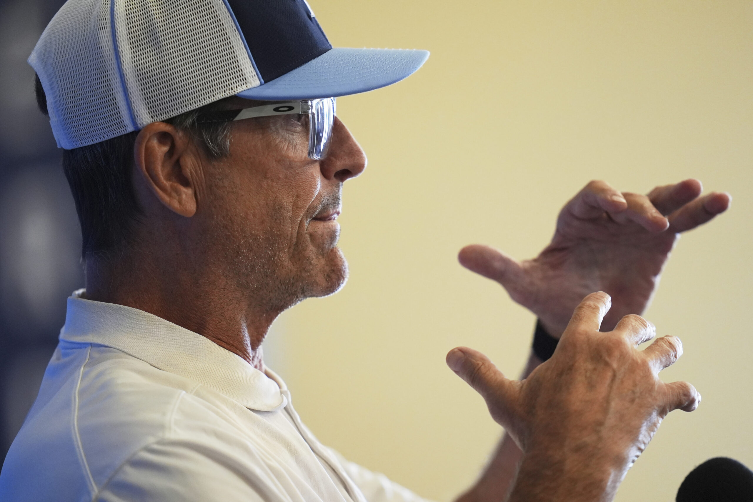 Chargers head coach Jim Harbaugh speaks to reporters during a...