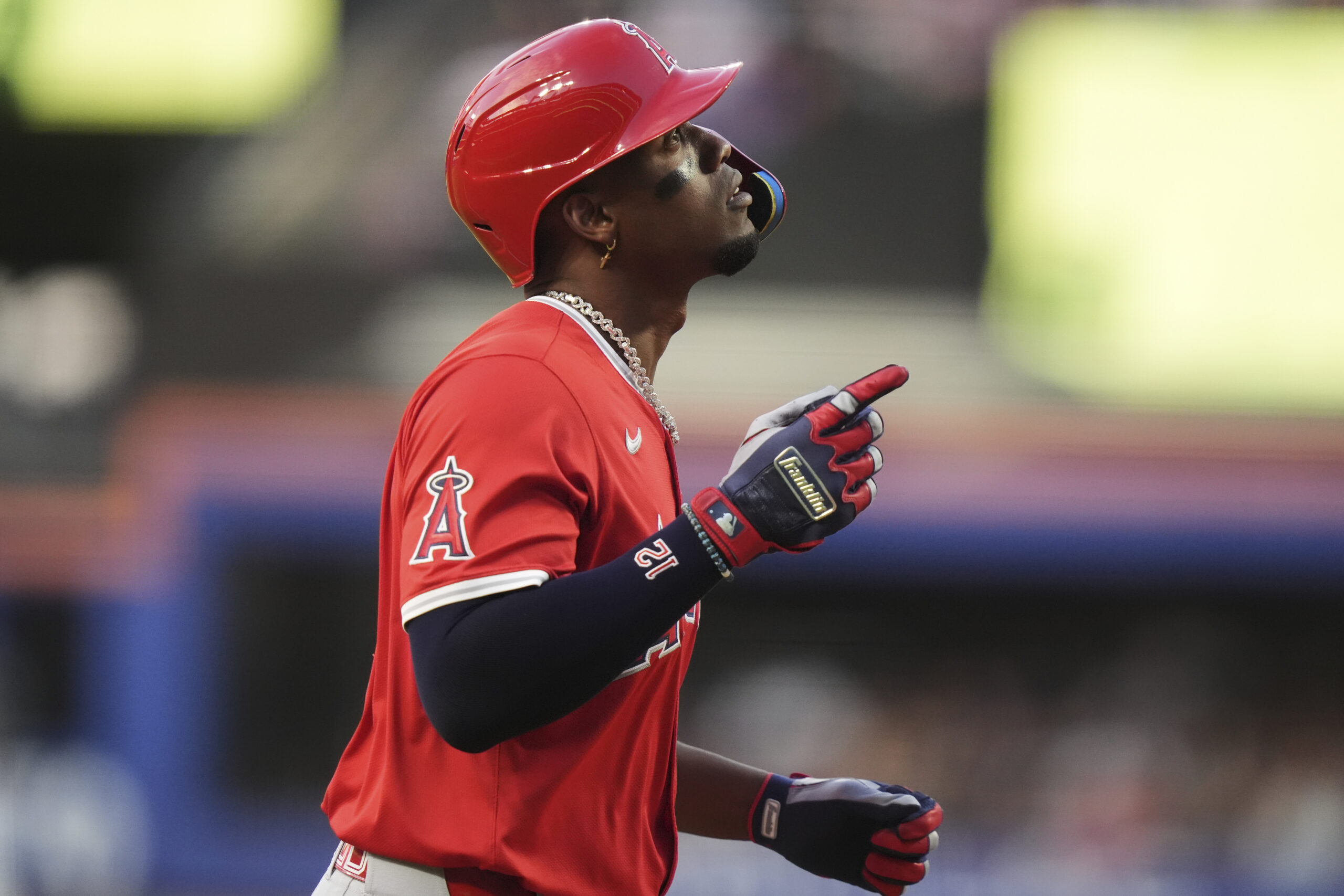 The Angels’ Jorge Soler gestures as he reaches home plate...