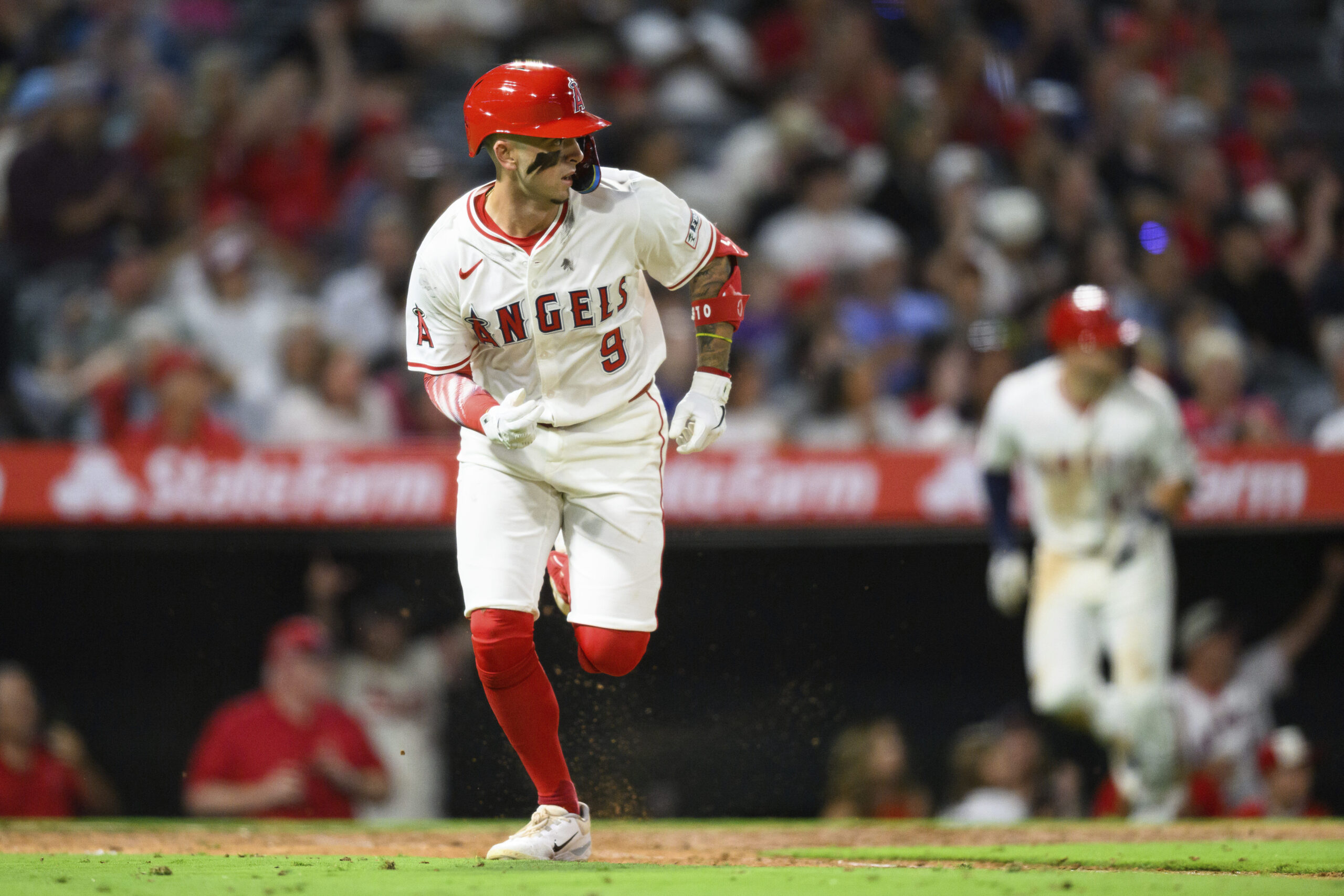 Angels Zach Neto runs the bases after hitting a RBI...