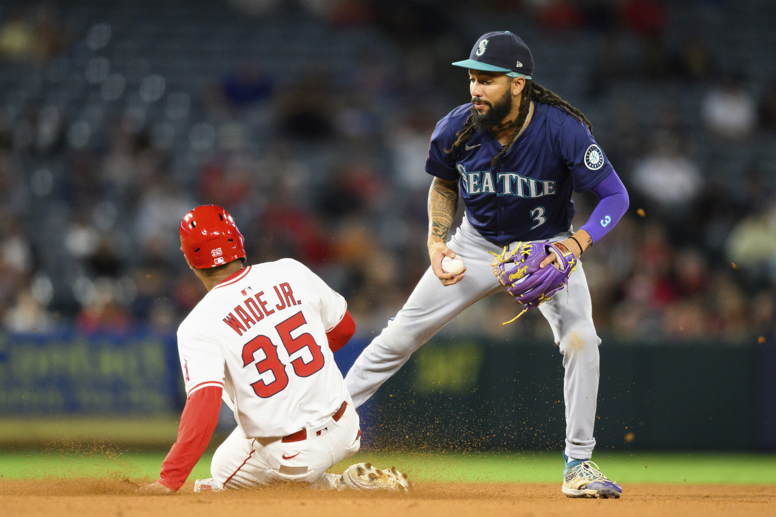 Seattle Mariners shortstop J.P. Crawford, right, forces out Angels LaMonte...
