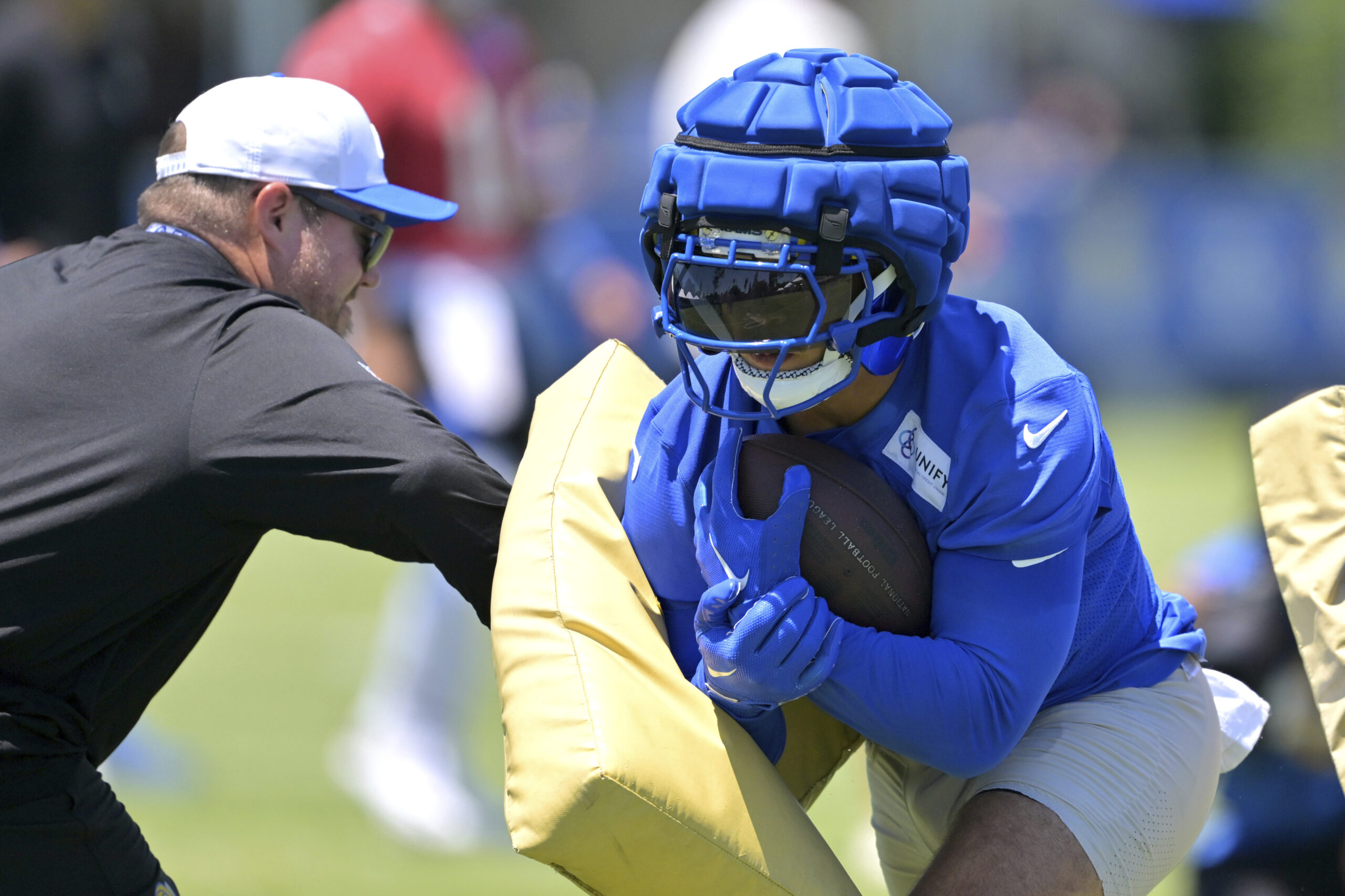 Rams running back Blake Corum goes through drills during a...