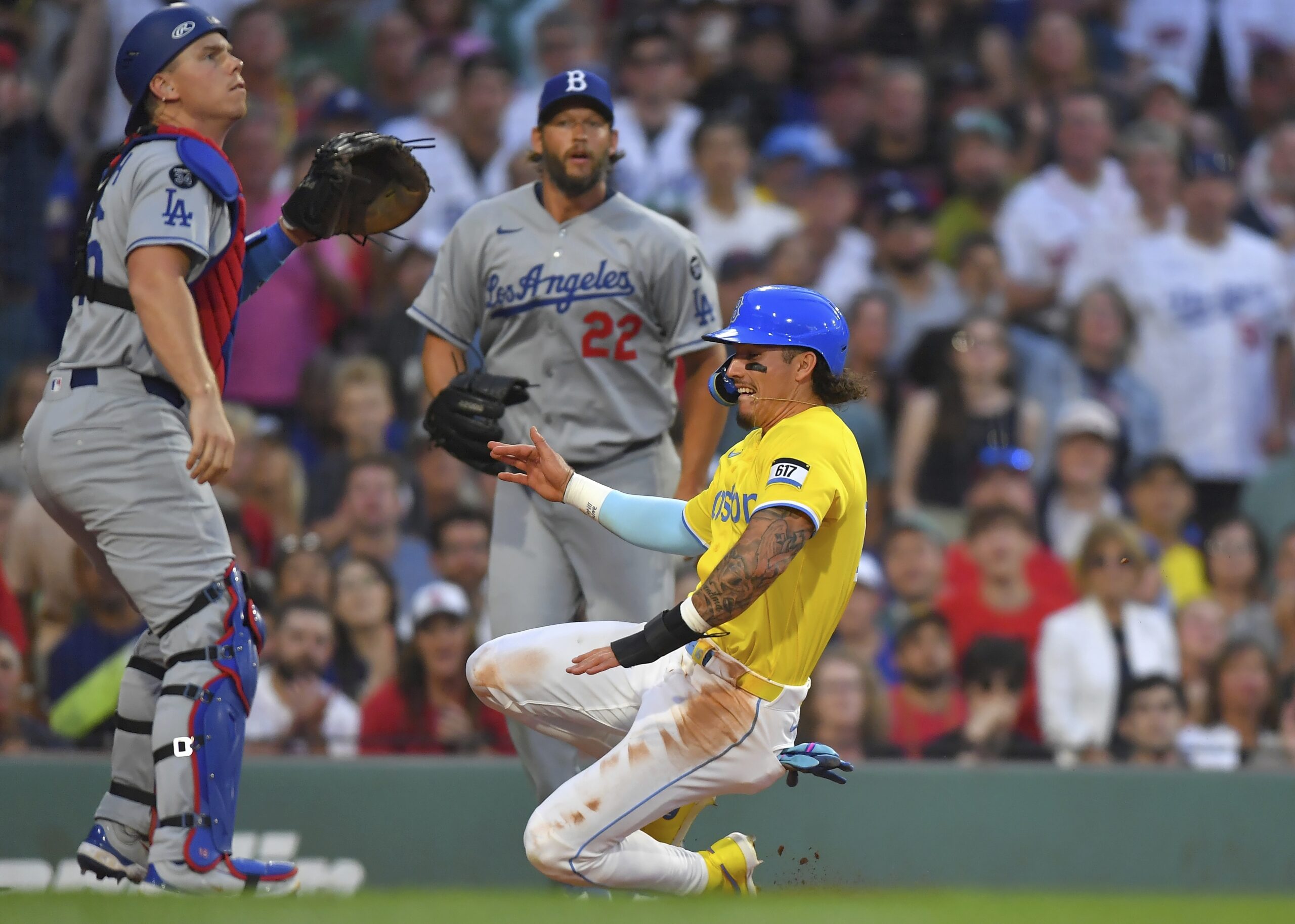 Boston Red Sox outfielder Jarren Duran, right, scores in front...