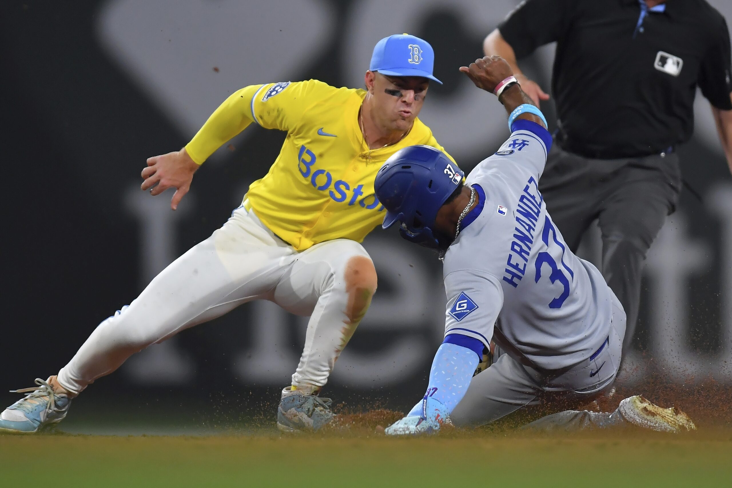 Dodgers’ Teoscar Hernández, right, slides out at second base on...