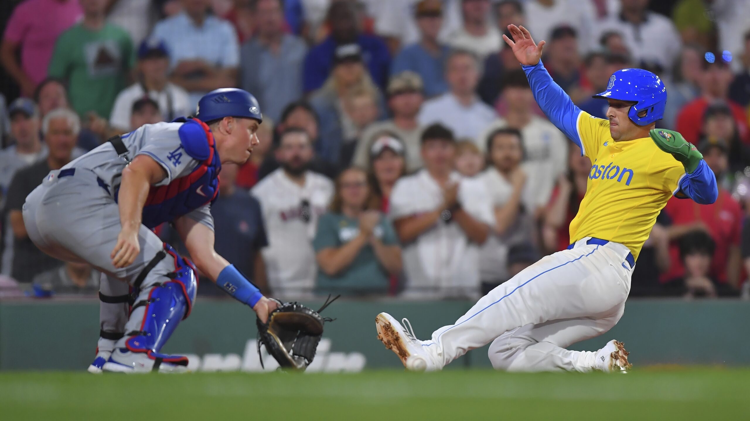 Boston Red Sox’s Alex Bregman, right, scores in front of...