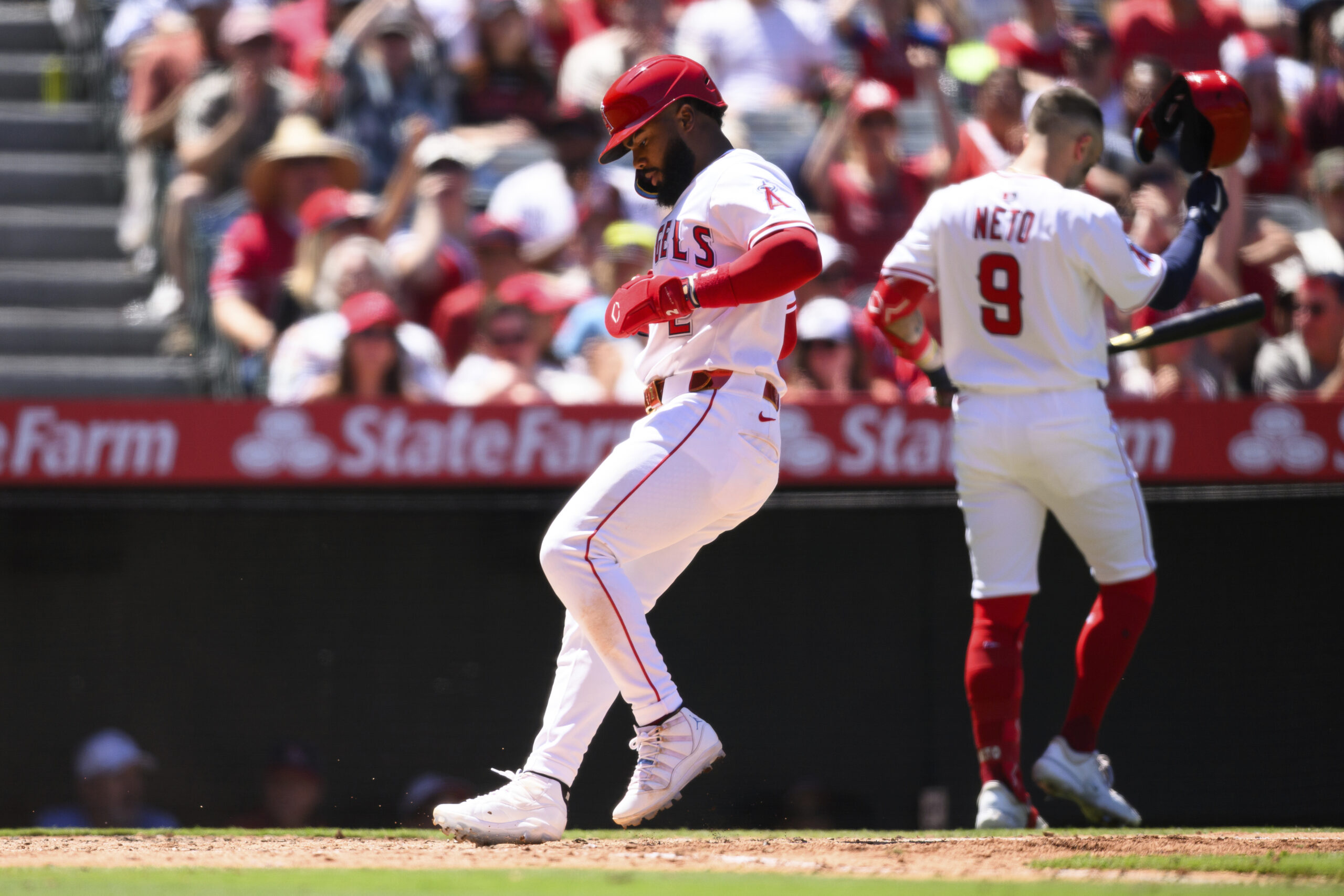Angels’ Luis Rengifo scores on a wild pitch during the...