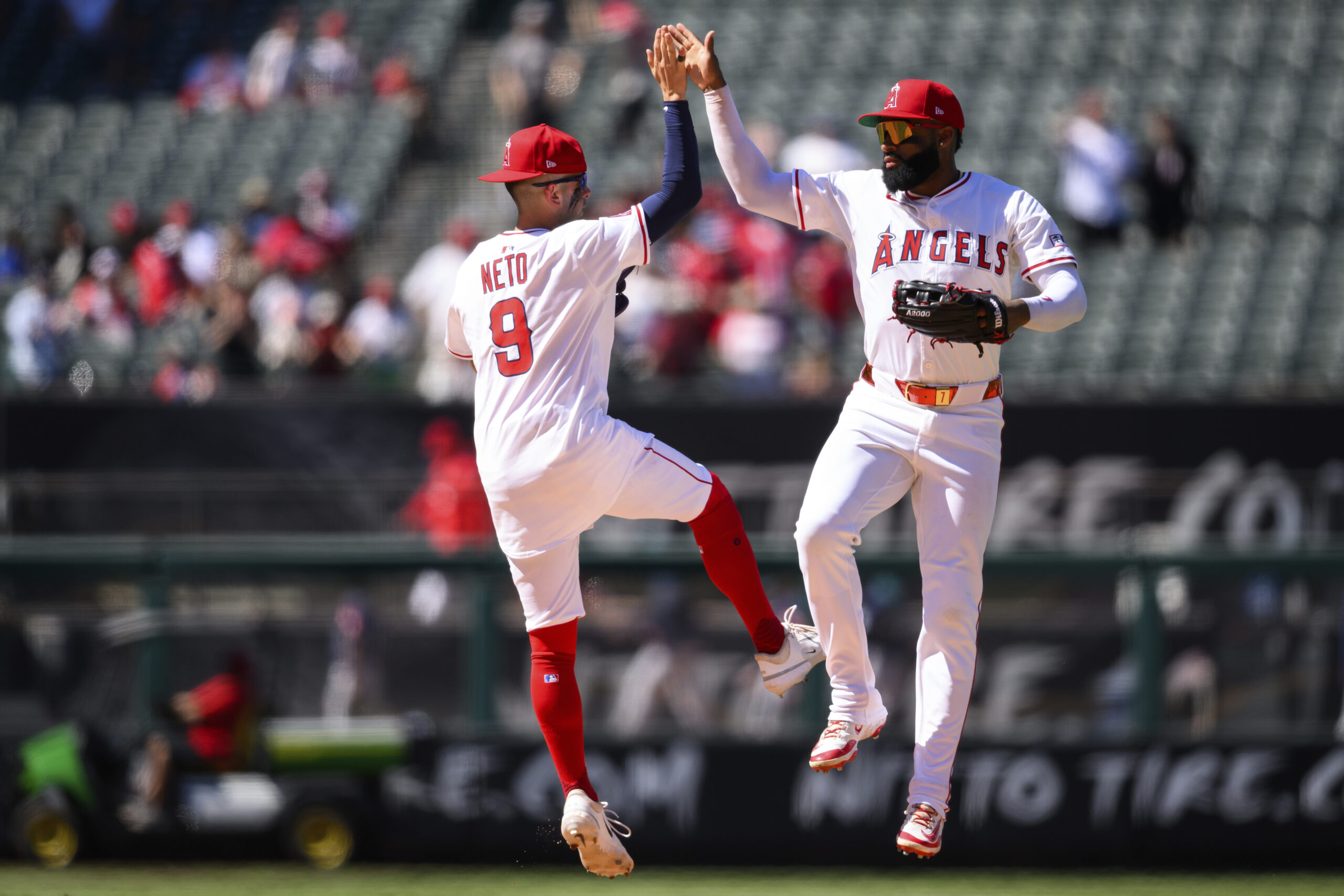 Angels center fielder Jo Adell, right, and shortstop Zach Neto,...