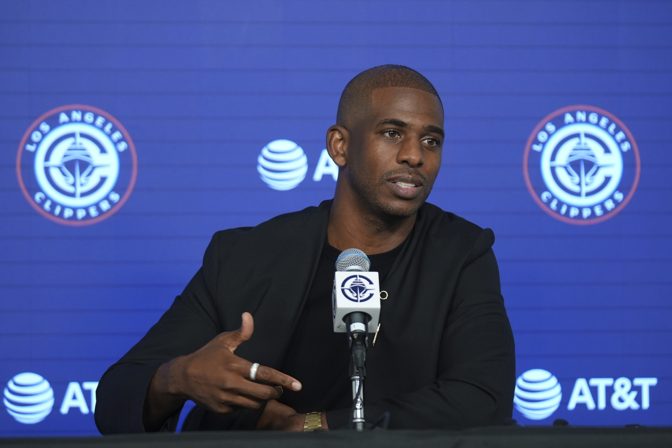 Clippers guard Chris Paul takes questions from reporters during a...